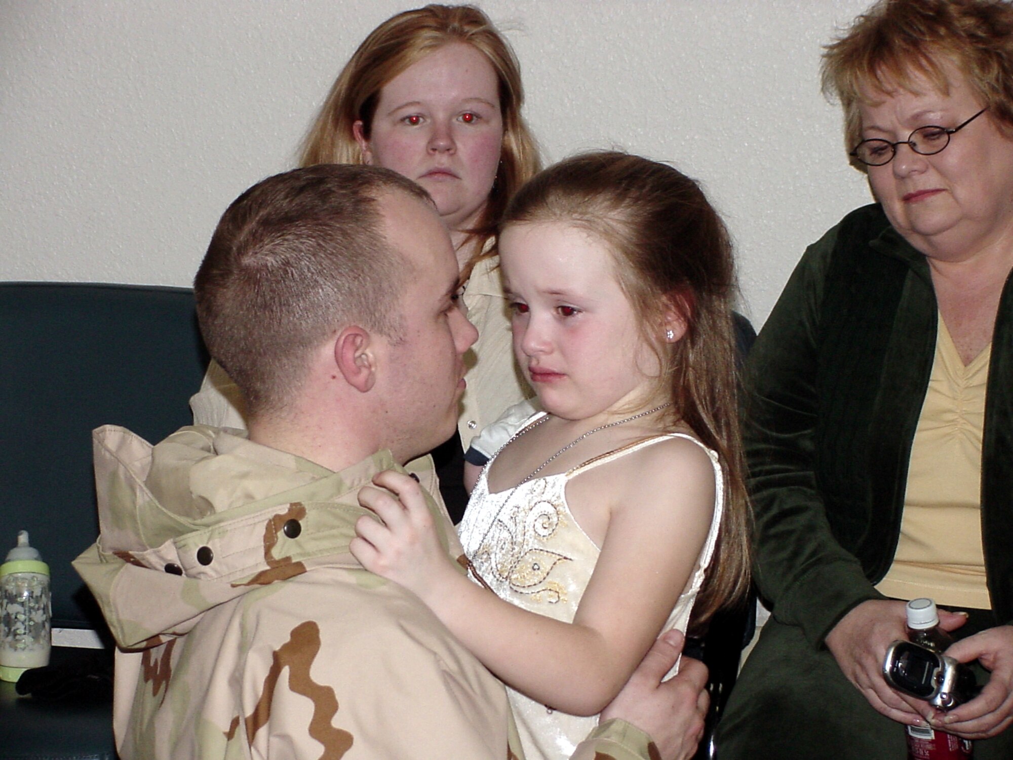 Staff Sgt. Jonathon Cagle, 60th Medical Support Squadron biomedical equipment repair technician, comforts his daughter Skylar prior to leaving for Afghanistan. Sergeant Cagle is one of more than 100 Airmen from the 60th Medical Group who have deployed to Bagram Air Base, Afghanistan to staff the Air Force Theater Hospital there. (U.S. Air Force photo by Jim Spellman)