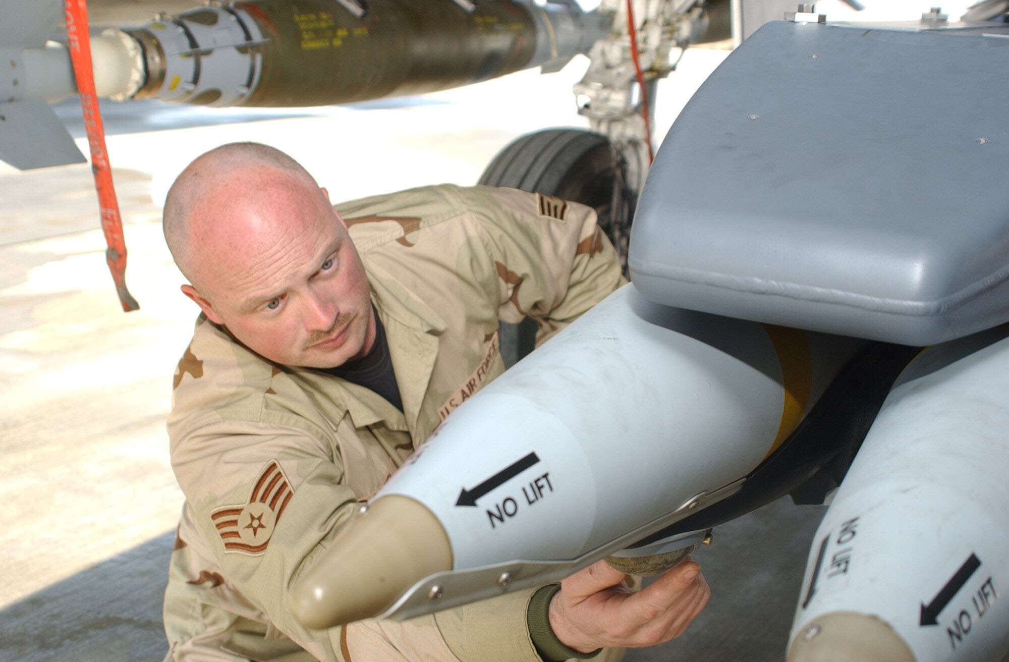 BAGRAM AIRFIELD, Afghanistan -- Staff Sgt. Russell David, 455th Expeditionary Aircraft Maintenance Squadron weapons load crew chief, inspects a GBU-39 Small Diameter Bomb on an F-15E Strike Eagle at Bagram Airfield, Afghanistan, Jan. 26. The Small Diameter Bomb is a 250-pound satellite-guided bomb designed to be more accurate than traditional bombs with less possibility of collateral damage. The sergeant recently deployed to Bagram from Mountain Home Air Force Base, Idaho. Air Force photo by Staff Sgt. Thomas J. Doscher