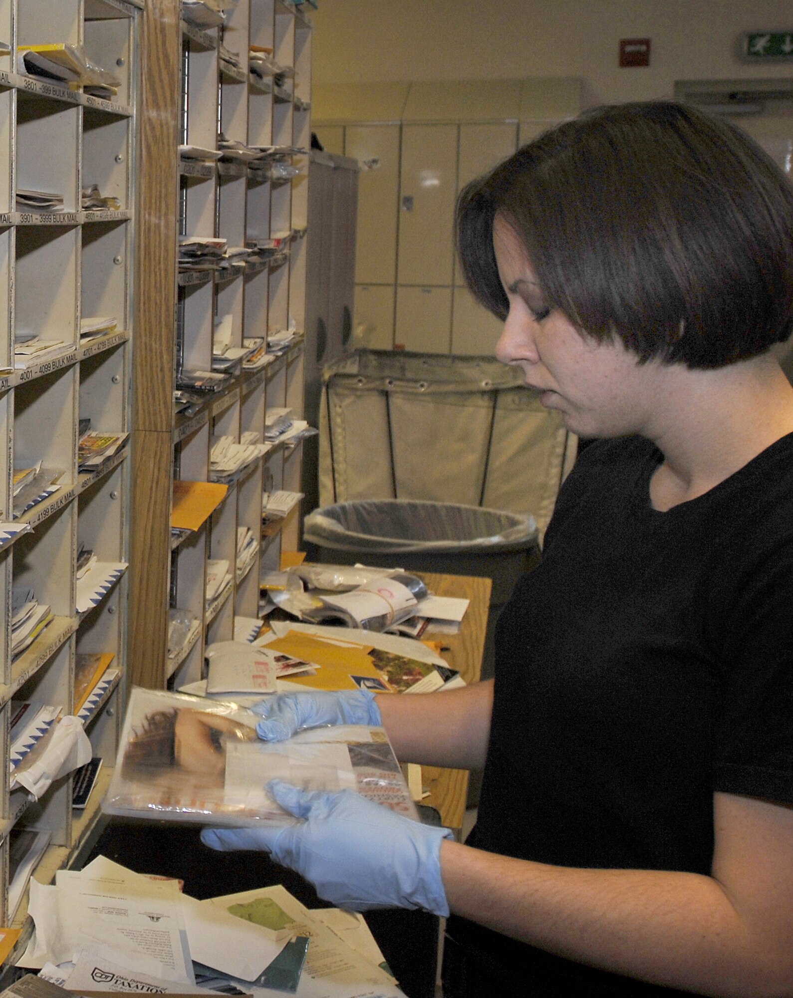 Senior Airman Amanda Turnbo, 31st CS postal clerk, sorts mail into Aviano’s mail boxes. The post office is responsible for delivering up to 2,600 pieces of mail per day.   (Photo by Airman 1st Class Liliana Moreno)