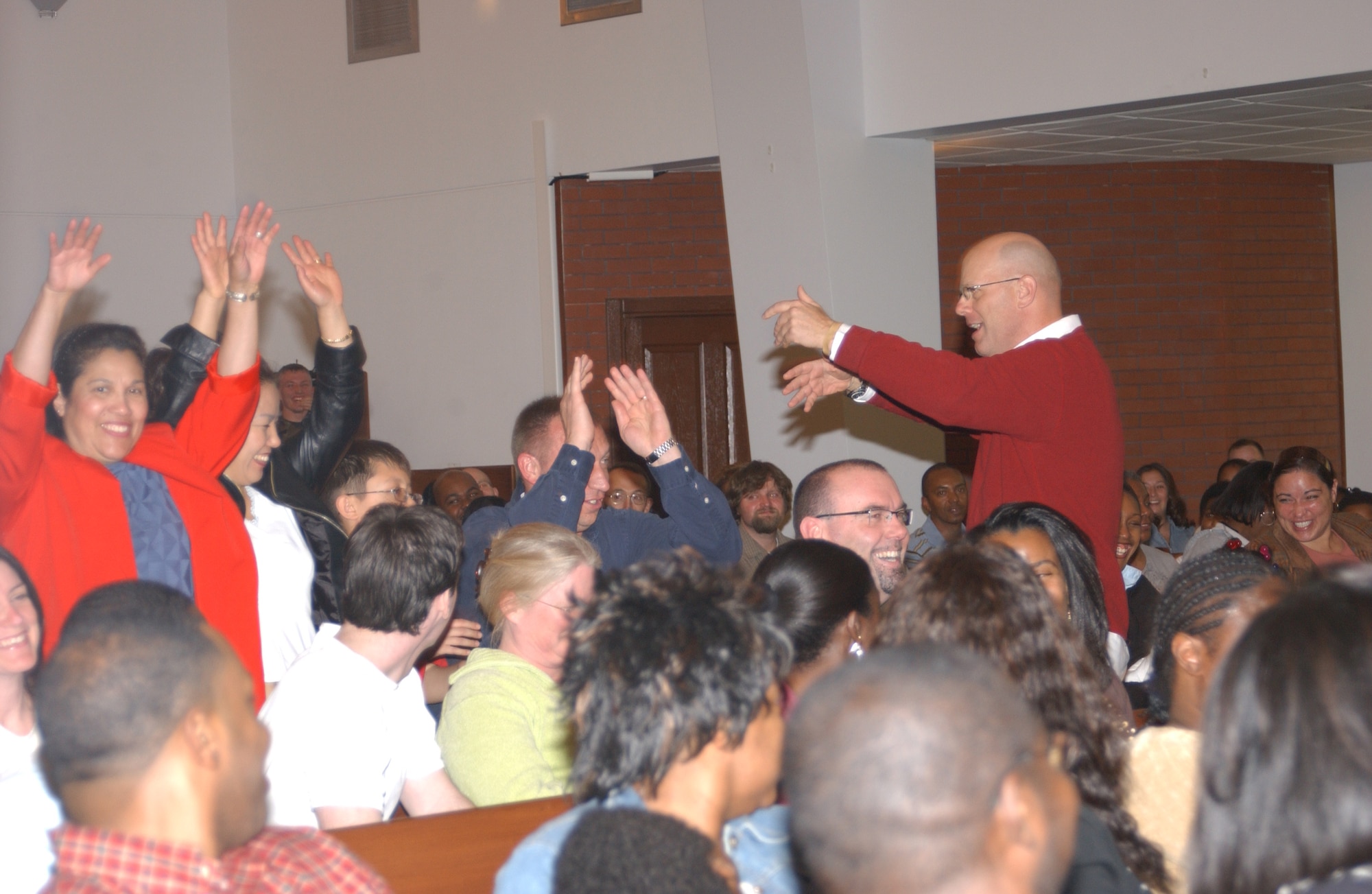 Participants at the National Prayer Observance Jan. 26, do the wave after hearing Maj. Gen. Charles Baldwin's, Air Force chief of Chaplains, message at the Chapel. More than 240 Team Incirlik members attended the observance which is traditionally held as a breakfast, but was changed to accomodate the Team Incirlik community. (U.S. Air Force Photo by Airman 1st Class Tiffany Colburn)