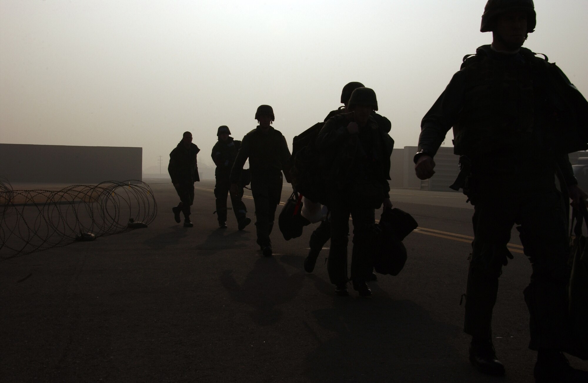 OSAN AIR BASE, Republic of Korea --  Members of the 36th Fighter Squadron bug out to the 25th Fighter Squadron after an attack on Osan. The “attack” left the building on fire. (U.S. Air Force photo by Airman 1st Class Chad Strohmeyer)