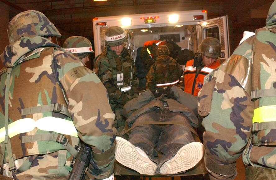 OSAN AIR BASE, Republic of Korea --  Combat Medics from the 51st Medical Group unload a patient from an emergency
vehicle during a mass casualty exercise Jan. 25. (U.S. Air Force photo by Senior Airman Eunique Stevens)