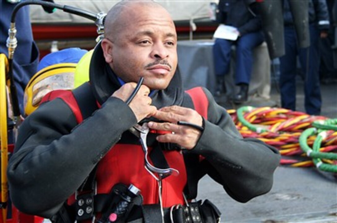 Senior Chief Petty Officer Michael Bowe-Rahming prepares for a training dive aboard the rescue and salvage ship USS Safeguard during at-anchor dive operations off the coast of its forward-deployed home of Sasebo-Japan, Jan. 30, 2007. 