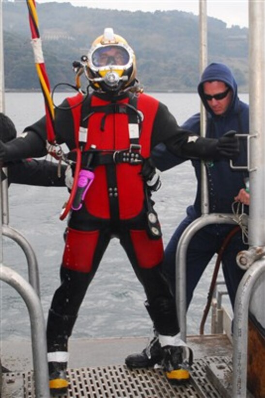 U.S. Navy Petty Officer 2nd Class Ryan Steinkemp assigned as a diver to the USS Safeguard (ARS 50) stands on a dive platform prior to at-anchor dive operations off the coast of Sasebo, Japan, on Jan. 30, 2007.  The Safeguard is conducting dive operations to increase proficiency as the ship approaches bi-lateral training commitments throughout the Western Pacific region.  