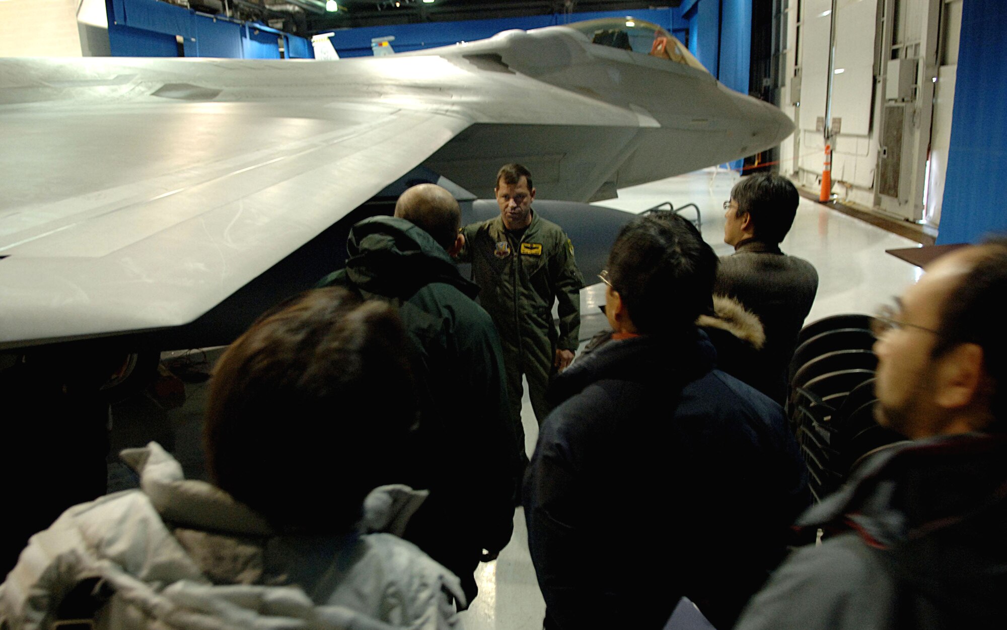 Lt. Col. Wade Tolliver explains F-22 Raptor capabilities to Japanese media during a press conference Jan. 31 with F-22 maintainers and pilots who will be deploying to Kadena Air Base later this month. The deployment to the Pacific Air Forces installation is the first real world deployment for the 27th Fighter Squadron with the Raptor. Colonel Tolliver is the squadron commander. (U.S. Air Force photo/Staff Sgt. Samuel Rogers)
