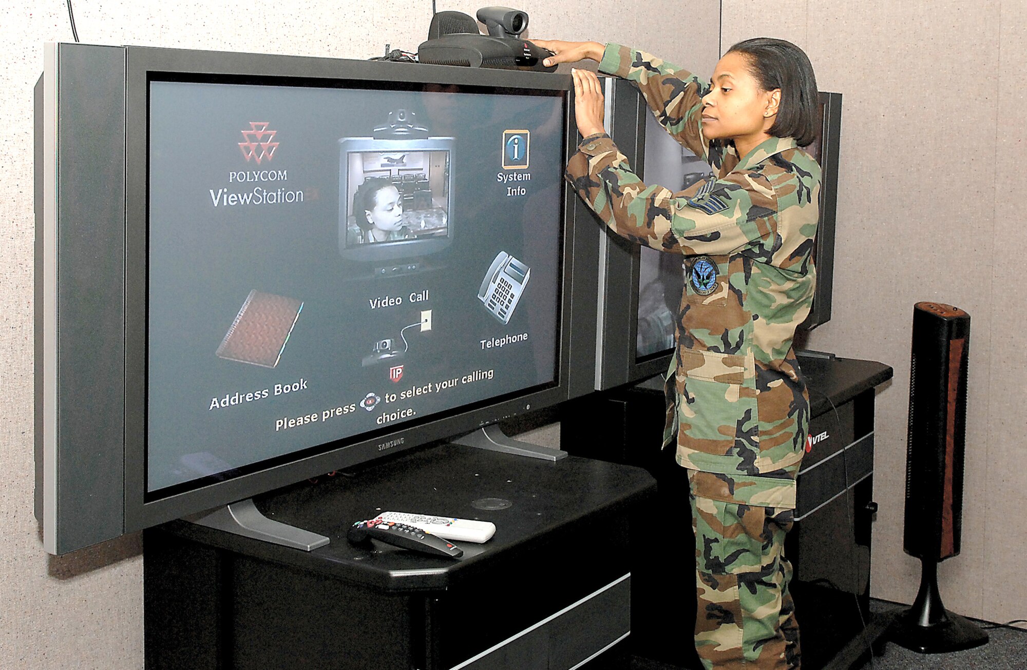 Staff Sgt. Tian Martel, 27th Communications Squadron graphics artist, sets up the Video Teleconference Center at Cannon Air Force Base, N.M. on Jan. 30. The VTC is used by 27th Fighter Wing to communicate more effectively with Air Force commands than regular conference calls. 