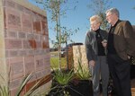 Lois and Fred Jones admire a wall of engraved bricks built at a gazebo between Lackland Air Force Base's Fisher House I and II. They are among brick donors who attended a Jan. 25 dedication of the wall. The donors helped pay Fisher House operating expenses from 1999 to 2005. (USAF photo by Robbin Cresswell) 
