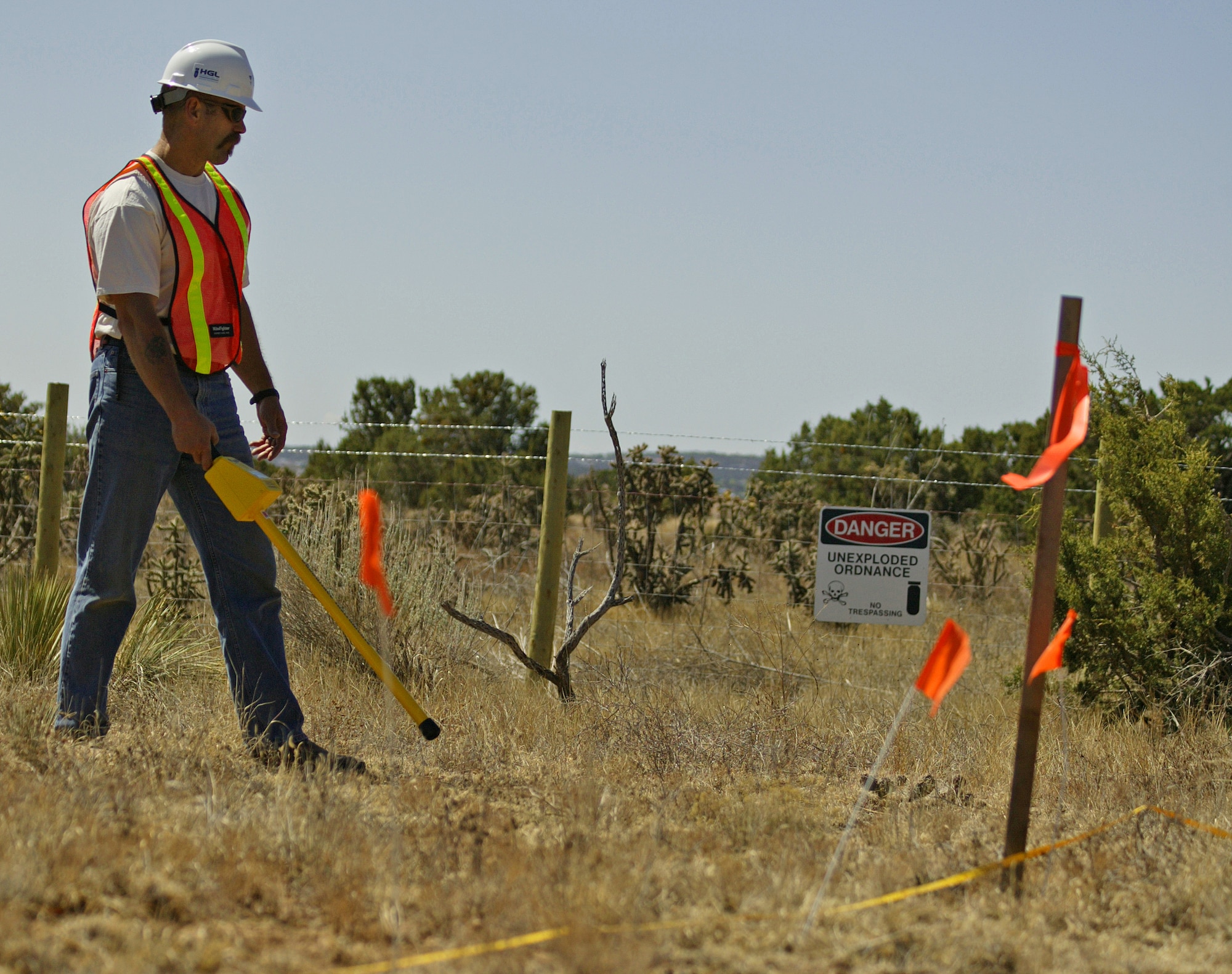 An unexploded ordnance technician scans a field for munitions and other debris. Ground based sweeps will also take place on base while areas are being surveyed. (Courtesy photo)
