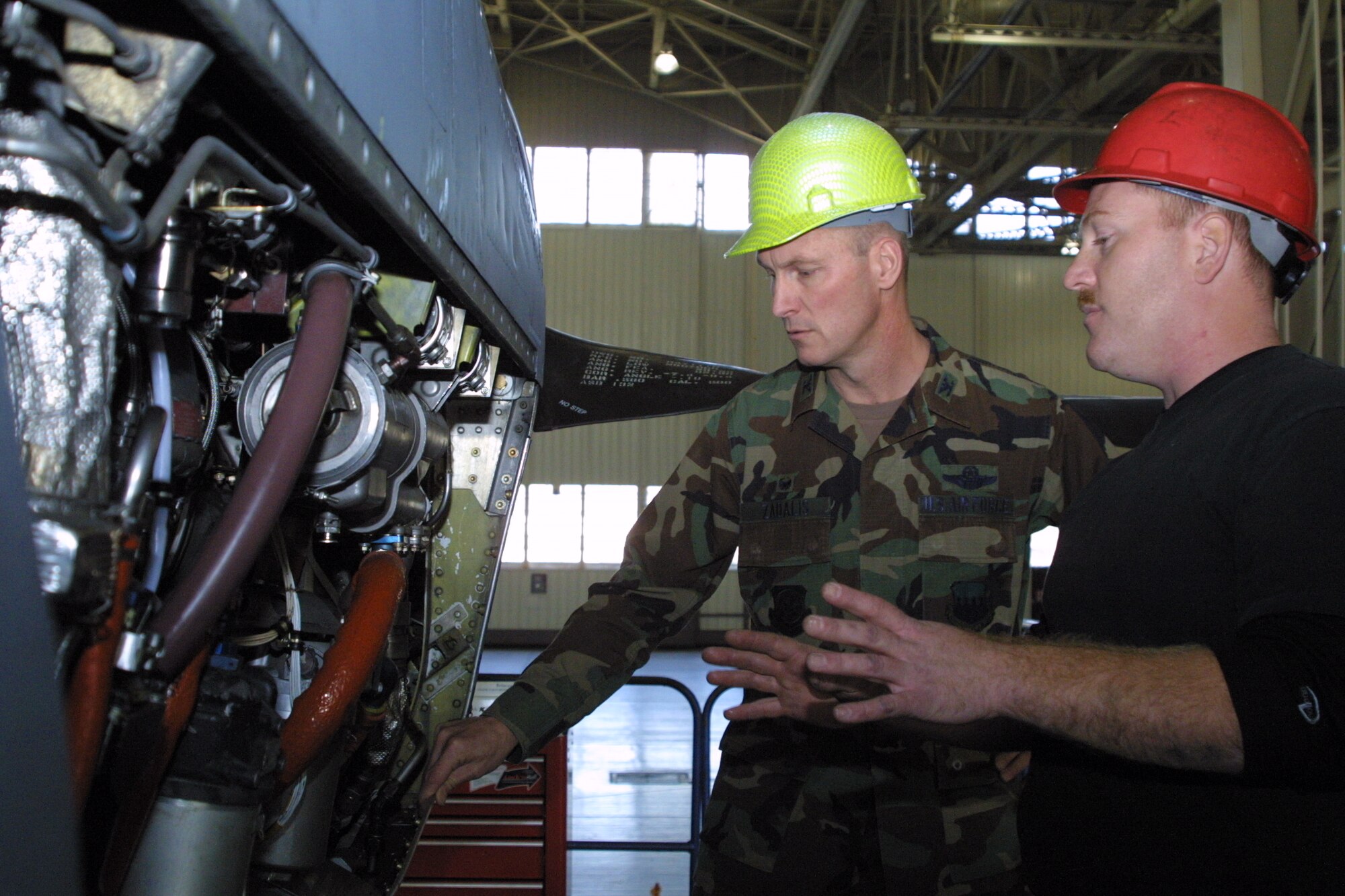 Tech. Sgt. Robert Aston, NCO in charge of the 43rd Maintenance Squadron engine shop, explains the ins and outs of ongoing maintenance to one of Pope's C-130s to Col. Timothy Zadalis, 43rd Airlift Wing Commander, Tuesday.