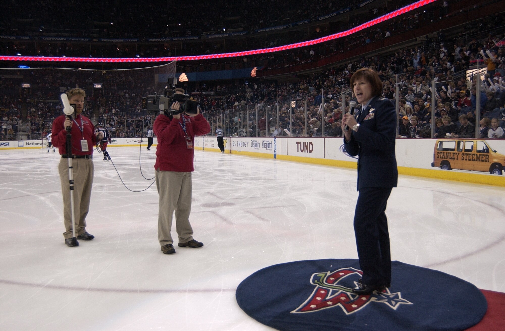 Col. Colleen Ryan, 88th Air Base Wing commander, asks fans, “What time is it?” — a traditional question for the pre-game show. The fans respond with, “It’s Jackets time!” In addition to ice time, Col. Ryan was interviewed by Columbus Blue Jackets TV and radio, toured the arena and was given a commemorative jersey with the No. 88 on the back. The NHL game at Nationwide Arena honored the Air Force's 60th Anniversary and was broadcast via satellite by Armed Forces Radio and Television Service. (Air Force photo/Spencer P. Lane)
