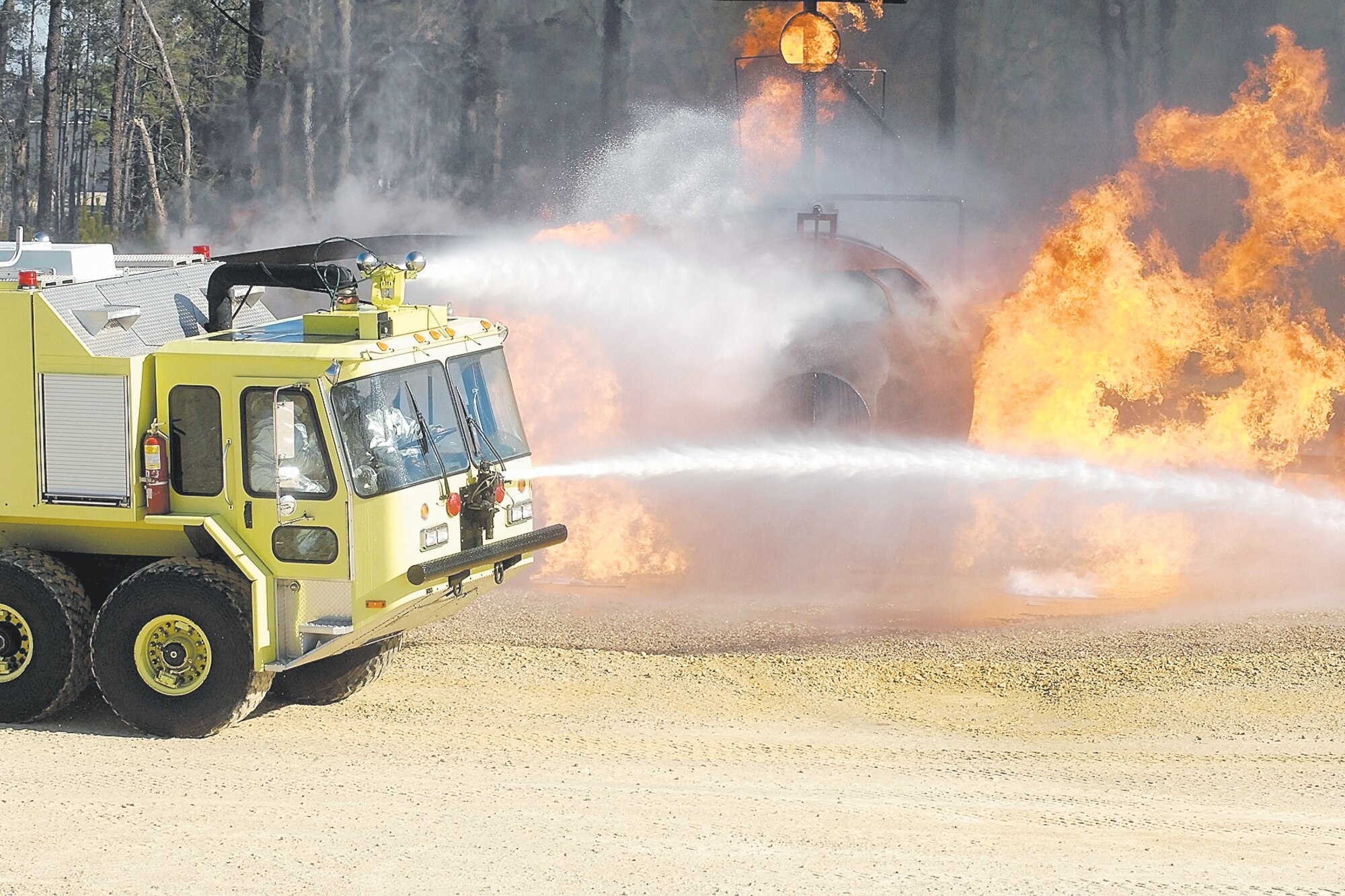 Firefighters from Pope Fire Department used a technique called "surround and drown" during training Jan. 26. Gen. Duncan McNabb, Air Mobility Command Commander, and Col. Timothy Zadalis, 43rd Airlift Wing Commander, each rode in a vehicle and operated a water cannon as the drivers maneuvered around the mock C-130.