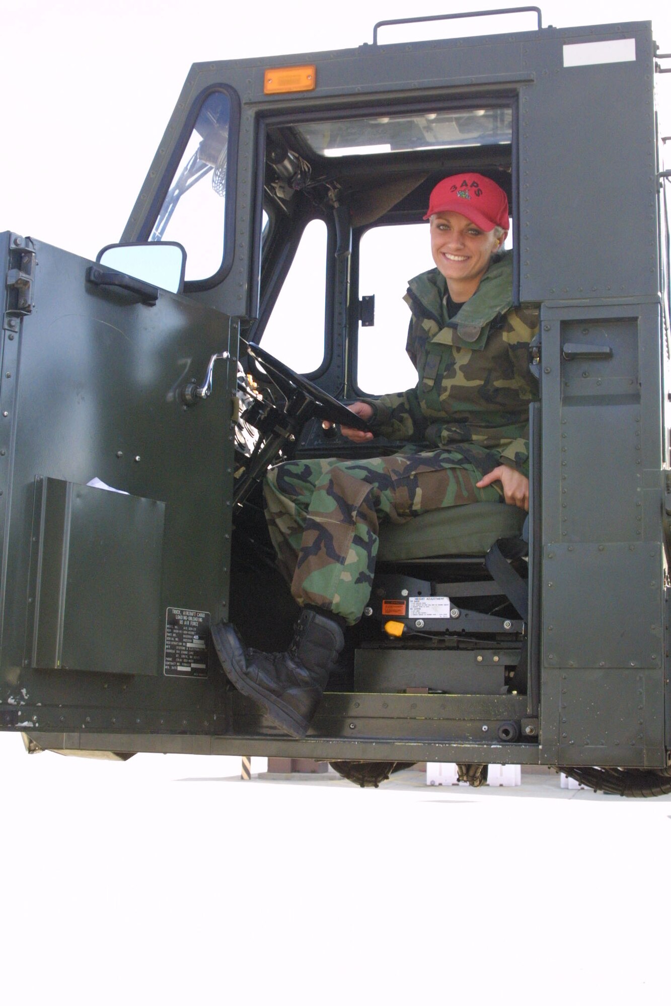 Airman 1st Class Heather Heininger, 3rd Aerial Port Squadron, sits in the "60-K loader" she would use to load and unload cargo from an aircraft.