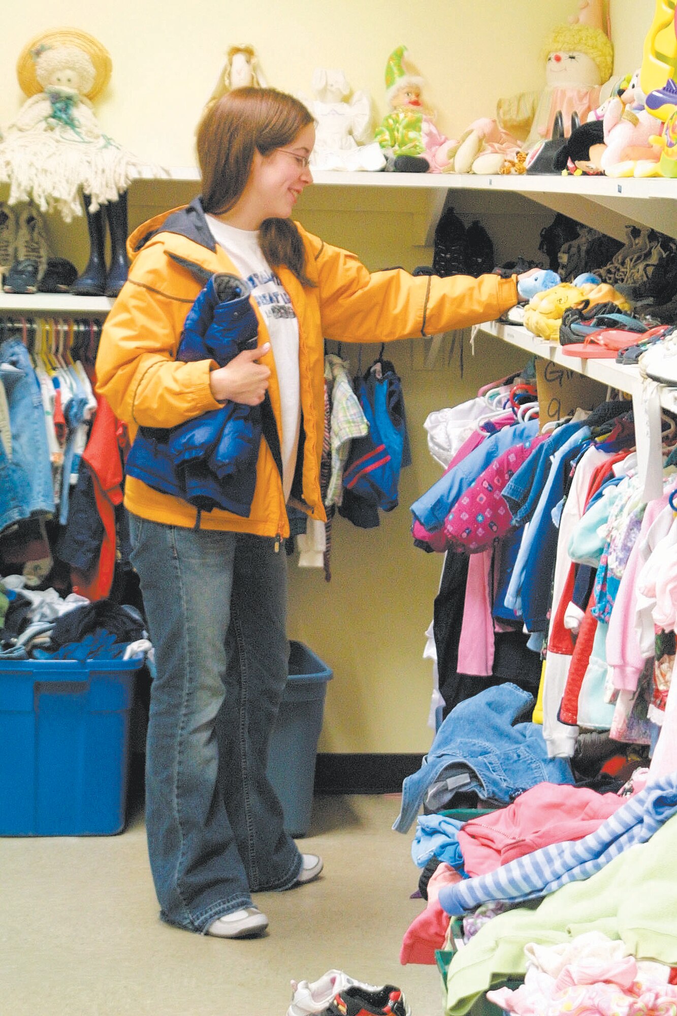 Charity Alonso, an Air Force spouse, looks for clothes that will fit her three children at the Airmen's Attic. Everything in the store is free for Airmen E-5 and below with fewer than eight years in service. (U.S. Air Force photo/Nicole Campbell)