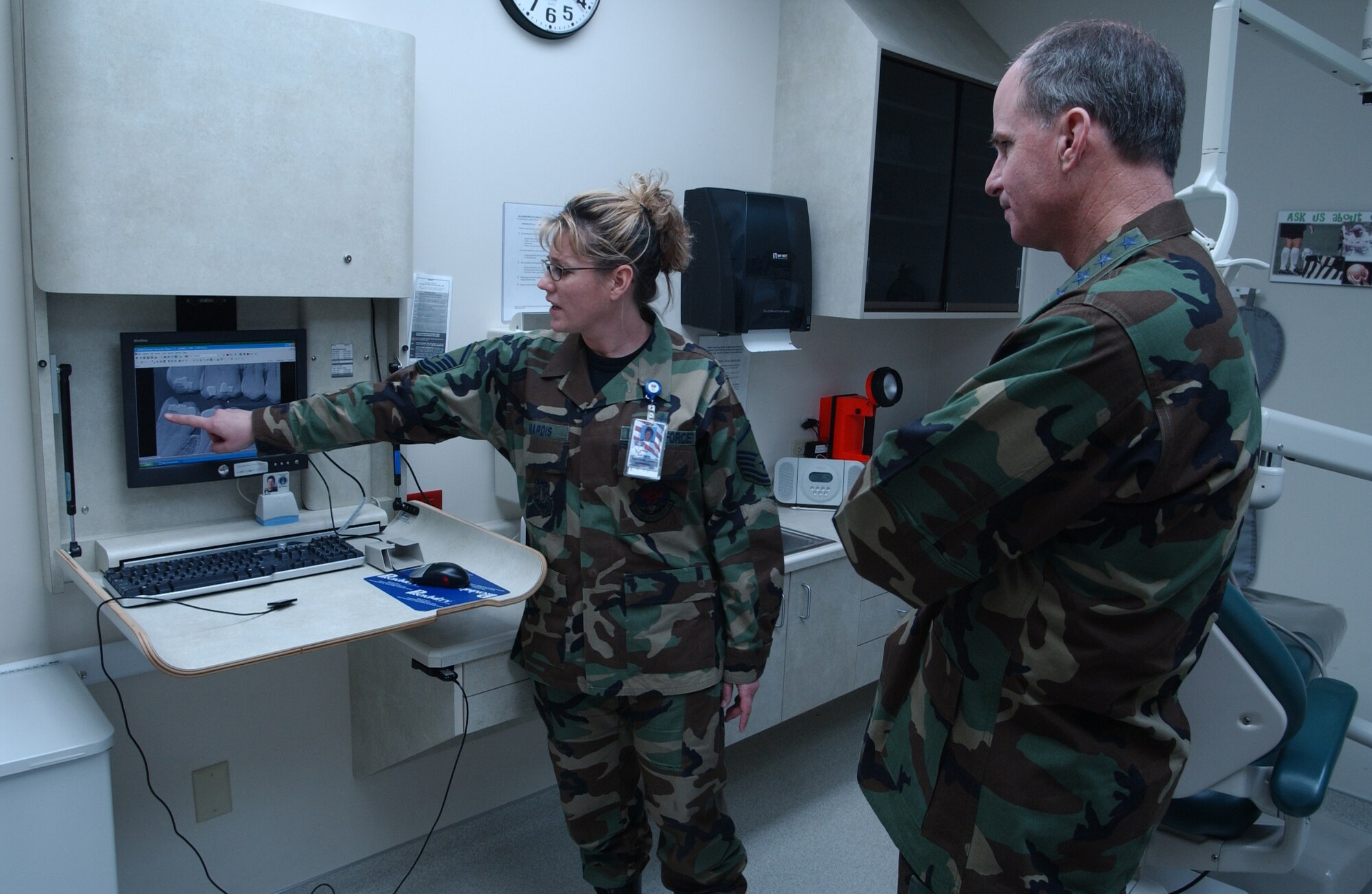 Master Sgt. Amy Mardis, Asistant NCOIC of the dental flight at the Malmstrom Clinic, briefs Gen. Kevin Chilton, Air Force Space Command commander, on the digital dental radiology being used in the clinic during his orientation visit to Malmstrom Jan. 24. The technology allows the dentist to review the same x-ray in different settings to better diagnose dental disease.