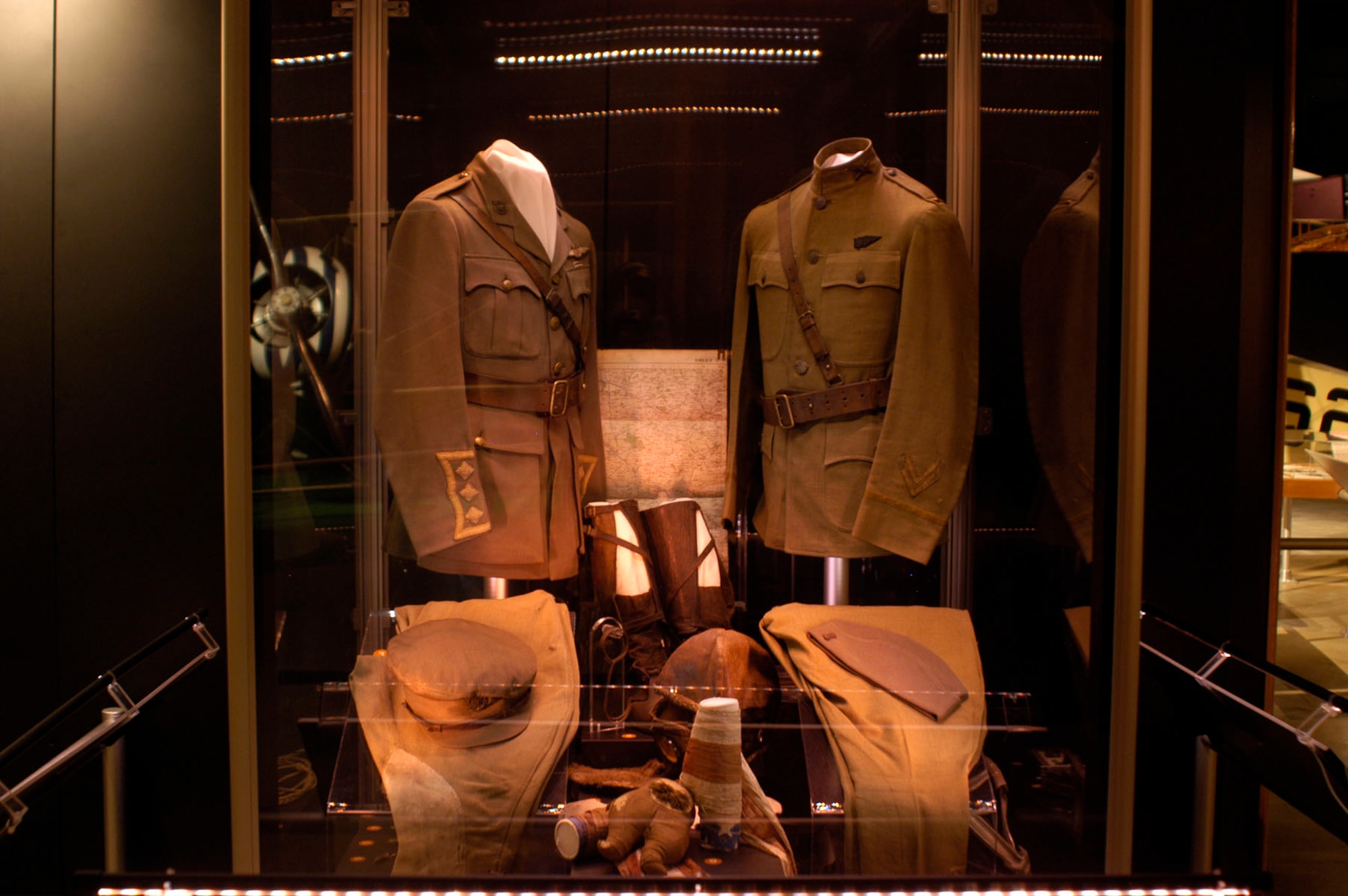 DAYTON, Ohio - (Left) British Royal Flying Corp cap, tunic, trousers and flying equipment worn by Capt. William C. Lambert during World War I. The bar decoration below the RFC wings on the tunic was the ribbon design for the original British Distinguished Flying Cross. (Right) Uniform items worn by Lt. Stephen W. Thompson on Feb. 5, 1918, when, while flying as an observer with the French, he became the first person in U.S. uniform to down an enemy airplane. (U.S. Air Force photo)