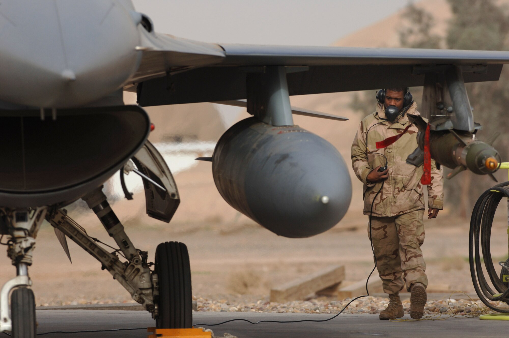Senior Airman Robert Gattison communicates with the pilot of this F-16 Fighting Falcon Jan. 29 during a pre-flight check at Balad Air Base, Iraq, before the aircraft takes off on a combat mission.  Airman Gattison is a crew chief with the 14th Expeditionary Aircraft Maintenance Squadron.  (U. S. Air Force photo/Staff Sgt. Michael R. Holzworth)

