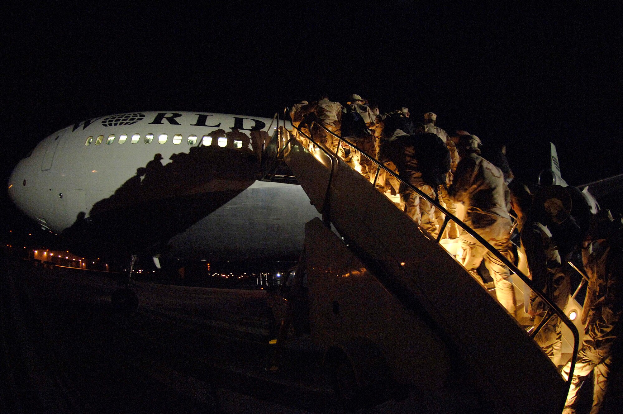 Airmen from the 28th Bomb Wing board an aircraft Jan. 28 to deploy from Ellsworth Air Force Base, S.D., to Southwest Asia.  Nearly 300 Ellsworth Airmen, in various roles, are deploying in support of operations Iraqi Freedom and Enduring Freedom.  (U.S. Air Force photo/Staff Sgt. Michael B. Keller) 