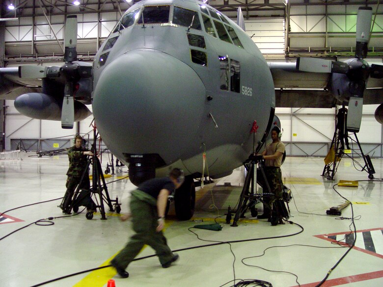 From left, Staff Sgt. Robert Burton, 352nd Maintenance Squadron guidance and control technician, Tech. Sgt. Heath Marinello, 352nd MXS Isochronal floor chief, and Senior Airman Dylan Goldwire, 352nd MXS isochronal inspection technician, operate aircraft jacks during a full-aircraft jack at RAF Mildenhall. (U.S. Air Force photo by Master Sgt. Dennis Brewer)