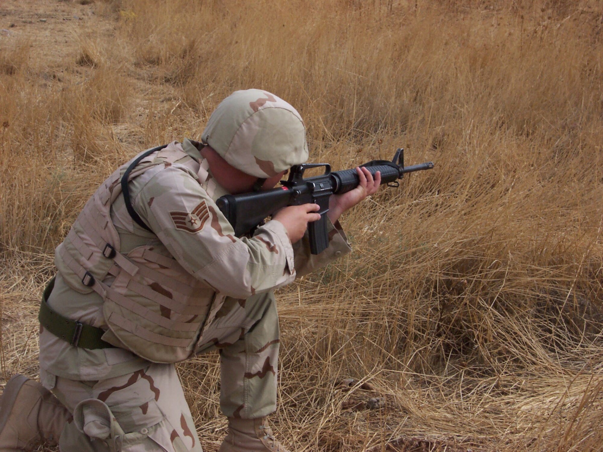 02/05/2007 -- SOUTHWEST ASIA -- A Misawa Airman takes a defensive position in a field outside of the perimeter at a forward operating location. (U.S. Air Force photo)