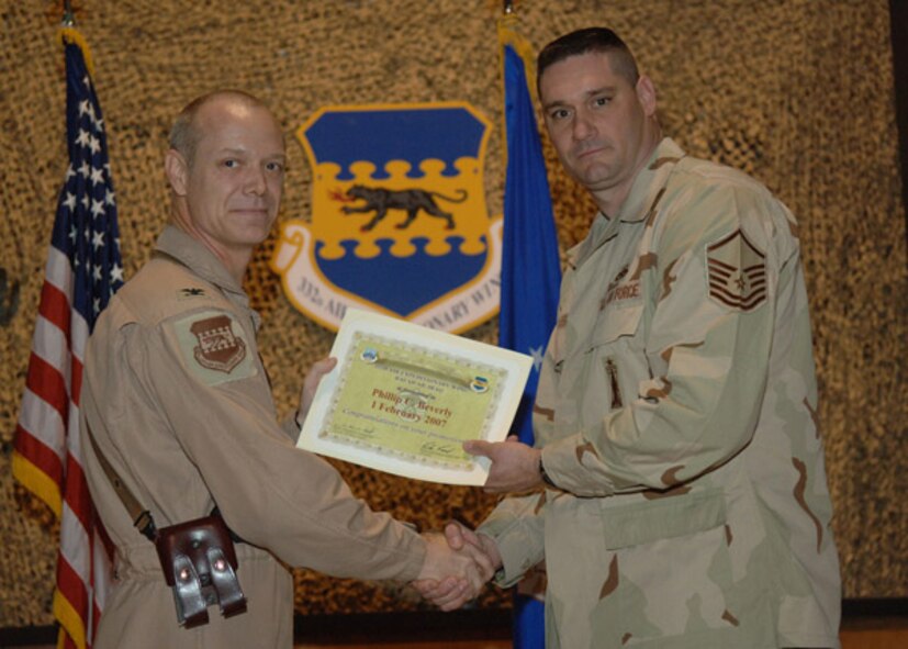 02/02/2007 -- SOUTHWEST ASIA -- Master Sgt. Philip Beverly, 35th Aircraft Maintenance Squadron, receives a certificiate from his deployed commander at Balad Air Base, Iraq. (U.S. Air Force photo)