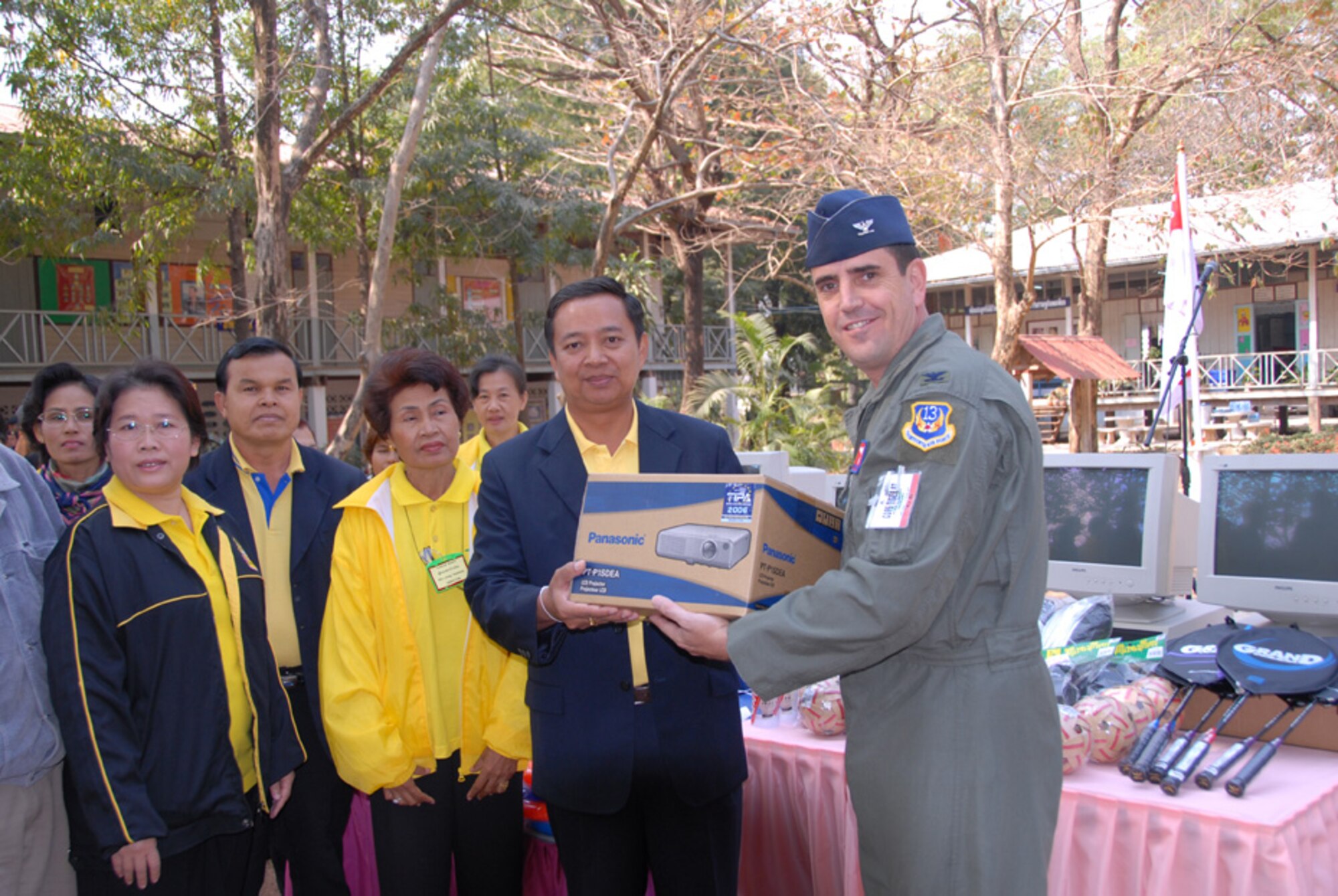 Col. Vincent Farrell, 13th Air Force Director of Air, Space and Information Operations, presents Anong Tangklang, the Ban Chaimongkon school director, with a digital projector from the U.S. Air Force, Marines and Navy. Servicemembers from the U.S., Thailand and the Republic of Singapore participating in Cope Tiger 2007 made donations of educational supplies to the school.  (USAF photo by Staff Sgt. Betty Squatrito-Martin)