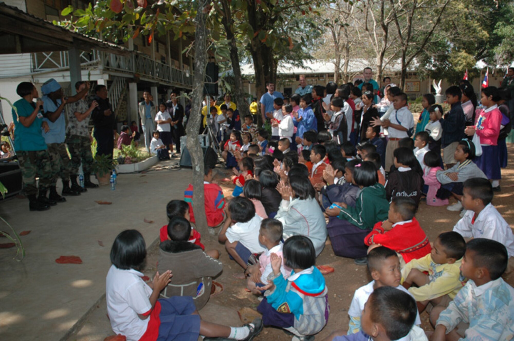 The U.S. dental staff takes time out of the day to entertain the students of Ban Chaimongkon school in Korat, Thailand. Medical personnel from the U.S., Thai, and Singapore Air Forces performed medical, dental and eye exams for members of the school community. (USAF photo by  Staff Sgt. Betty Squatrito-Martin)