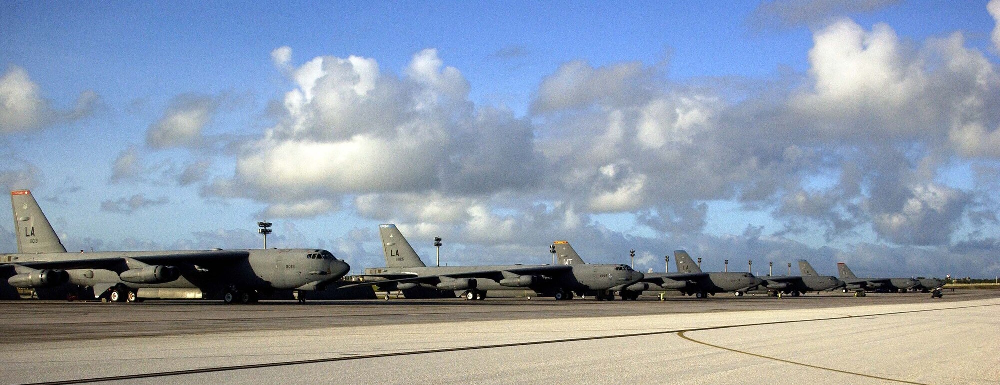 ANDERSEN AIR FORCE BASE, Guam –  A row of B-52 Stratofortresses from Barksdale Air Force Base, La. and Minot AFB, N.D. await their next mission on the flightline at Andersen AFB, Guam.  The different colored tail markings represent the individual squadrons each bomber is assigned to at their home station.  Approximately 300 Airmen from Barksdale AFB, La. arrived on Guam this week as part of a scheduled rotation of bomber units into the Pacific theatre.  (U.S. Air Force Photo by Senior Master Sgt. Don Perrien)
