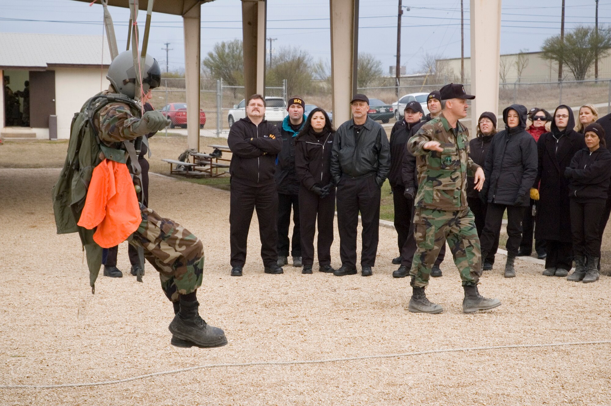 Master Sgt. Lee Diekmann, in charge of USAFSAM's Aerospace Physiology Formal Training Program, demonstrates parachute landing falls and swing landing procedures for ELDP members from a 20-foot tower at Brooks City-Base. (U.S. Air Force photo by Steve Thurow)