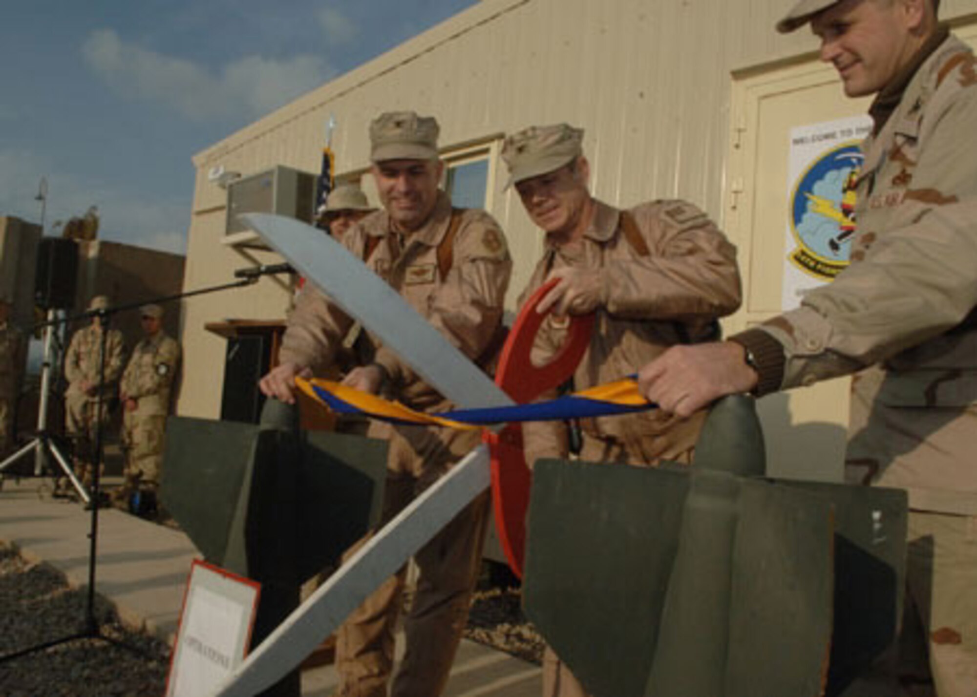01/27/2007 -- BALAD AIR BASE, Iraq -- Misawa Airmen cut the ribbon during a ceremony officially standing up the third fighter squadron at the base. The 14th Fighter Squadron deployed earlier this month in support of Operation Iraqi Freedom. (U.S. Air Force photo)