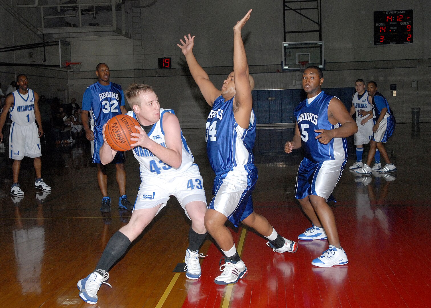 Kaleb Goss from the Lackland Warhawks attempts to pass while guarded by Reggie Hardin and Todd Hollis (5) from Brooks City-Base during Southwest Military Basketball League action Feb. 3 at the Chaparral Fitness Center on Lackland Air Force Base, Texas. Rodrick Greene scored 21 points and Goss scored 13 as the Warhawks won, 90-83. (USAF photo by Robbin Cresswell)
