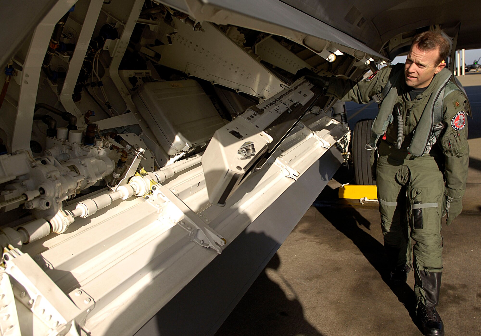 Maj. Patrick Deconcini performs a preflight inspection of an F-22 Raptor Feb. 3 at Langley Air Force Base in Virginia. The 94th Fighter Squadron is deploying for Red Flag at Nellis AFB, Nev. Red Flag is an air combat training exercise designed to test pilots and air support crews' ability to affectively respond to real-world combat scenarios. This is the first deployment to Red Flag for the 94th FS with F-22s. Major Deconcini is a 192nd Virginia Air National Guard pilot with the 94th Fighter Squadron. (U.S. Air Force photo/Staff Sgt. Samuel Rogers) 
