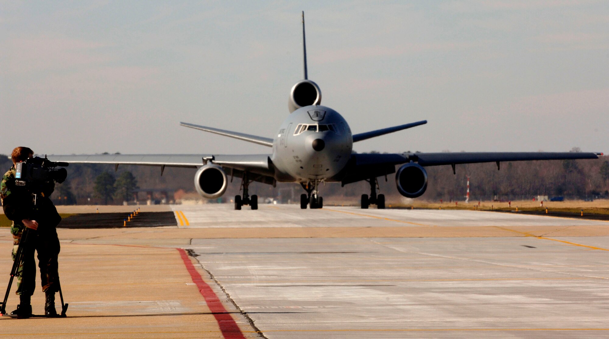 Senior Airman Matthew Clouse videotapes the departure of F-22 Raptors from the 94th Fighter Squadron and a KC-10 Extender carrying maintainers from the 94th Aircraft Maintenance Unit Feb. 3 at Langley Air Force Base in Virginia. The 94th Fighter Squadron and Aircraft Maintenance Unit are deploying to Nellis Air Force Base in Nevada for Red Flag. Red Flag is an air combat training exercise designed to test pilots and air support crews' ability to affectively respond to real-world combat scenarios. This is the first deployment to Red Flag for the 94th FS with F-22s. Colonel Smith is the 94th FS commander. Airman Clouse is a broadcaster with Air Combat Command Public Affairs. (U.S. Air Force photo/Staff Sgt. Samuel Rogers) 

