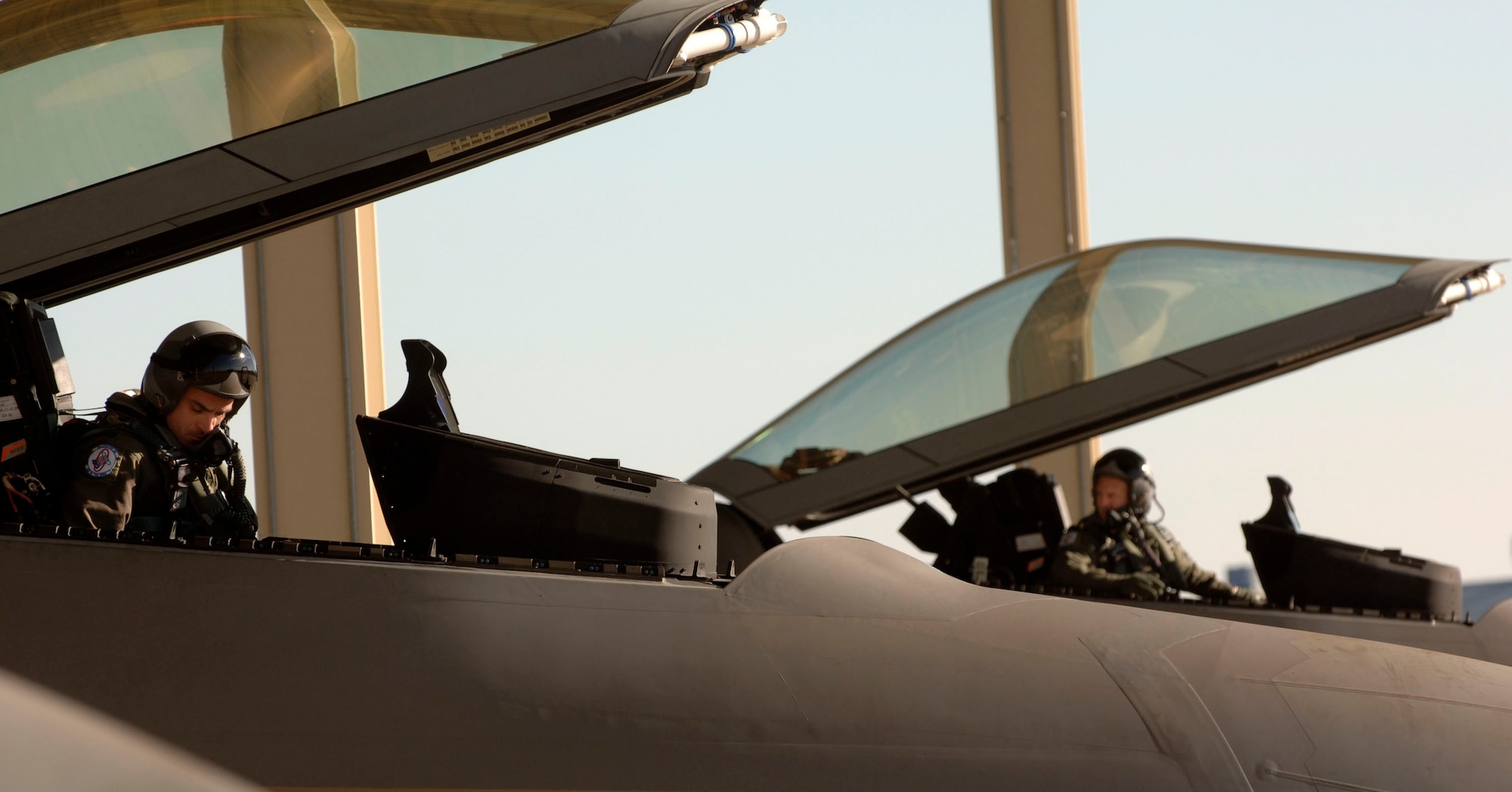 Lt. Col. Dirk Smith (far right)  and Capt. Merrick Baroni begin start up procedures in their respective F-22 Raptors Feb. 3 at Langley Air Force Base in Virginia.The 94th Fighter Squadron is deploying for Red Flag at Nellis AFB, Nev. Red Flag is an air combat training exercise designed to test pilots and air support crews' ability to affectively respond to real-world combat scenarios. This is the first deployment to Red Flag for the 94th FS with F-22s. Colonel Smith is the 94th FS commander. Colonel Smith is the commander and Captain Baroni is a pilot with the 94th FS. (U.S. Air Force photo/Staff Sgt. Samuel Rogers) 
