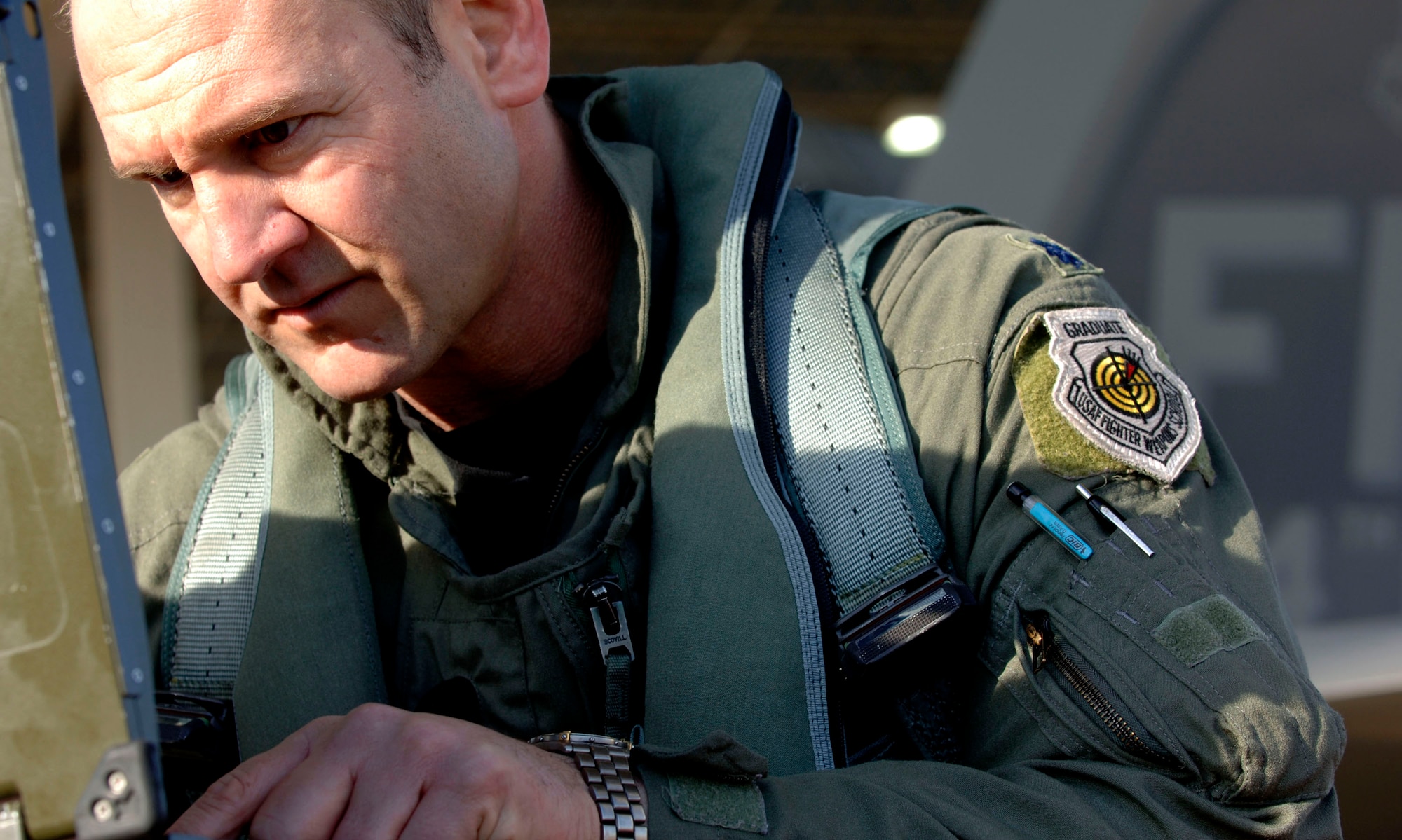 Lt. Col. Dirk Smith checks the F-22 Raptor aircraft forms on a portable maintenance adapter prior to launch Feb. 3 at Langley Air Force Base in Virginia.The 94th Fighter Squadron is deploying for Red Flag at Nellis AFB, Nev. Red Flag is an air combat training exercise designed to test pilots and air support crews' ability to affectively respond to real-world combat scenarios. This is the first deployment to Red Flag for the 94th FS with F-22s. Colonel Smith is the 94th FS commander. (U.S. Air Force photo/Staff Sgt. Samuel Rogers)
