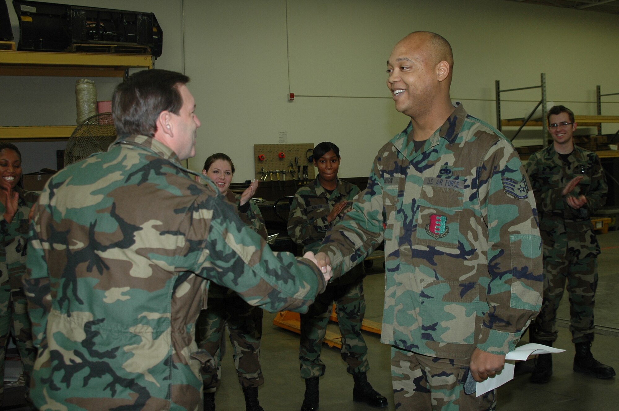 Col. Jeffry Smith, 28th Bomb Wing commander, congratulates Tech. Sgt. Joseph Gadson, 28th Logistics Readiness Squadron traffic management supervisor, on his promotion Feb. 2. Sergeant Gadson was promoted under the Air Force’s Stripes for Exceptional Performers program. The logistician was recognized for his extraordinary leadership skills, his implementation of quality control checklists involving hazardous material shipments and his involvement in shipping 2,800 pounds of B-1 parts to support the global war on terrorism. (U.S. Air Force photo/Capt. Carrie L. Kessler)

