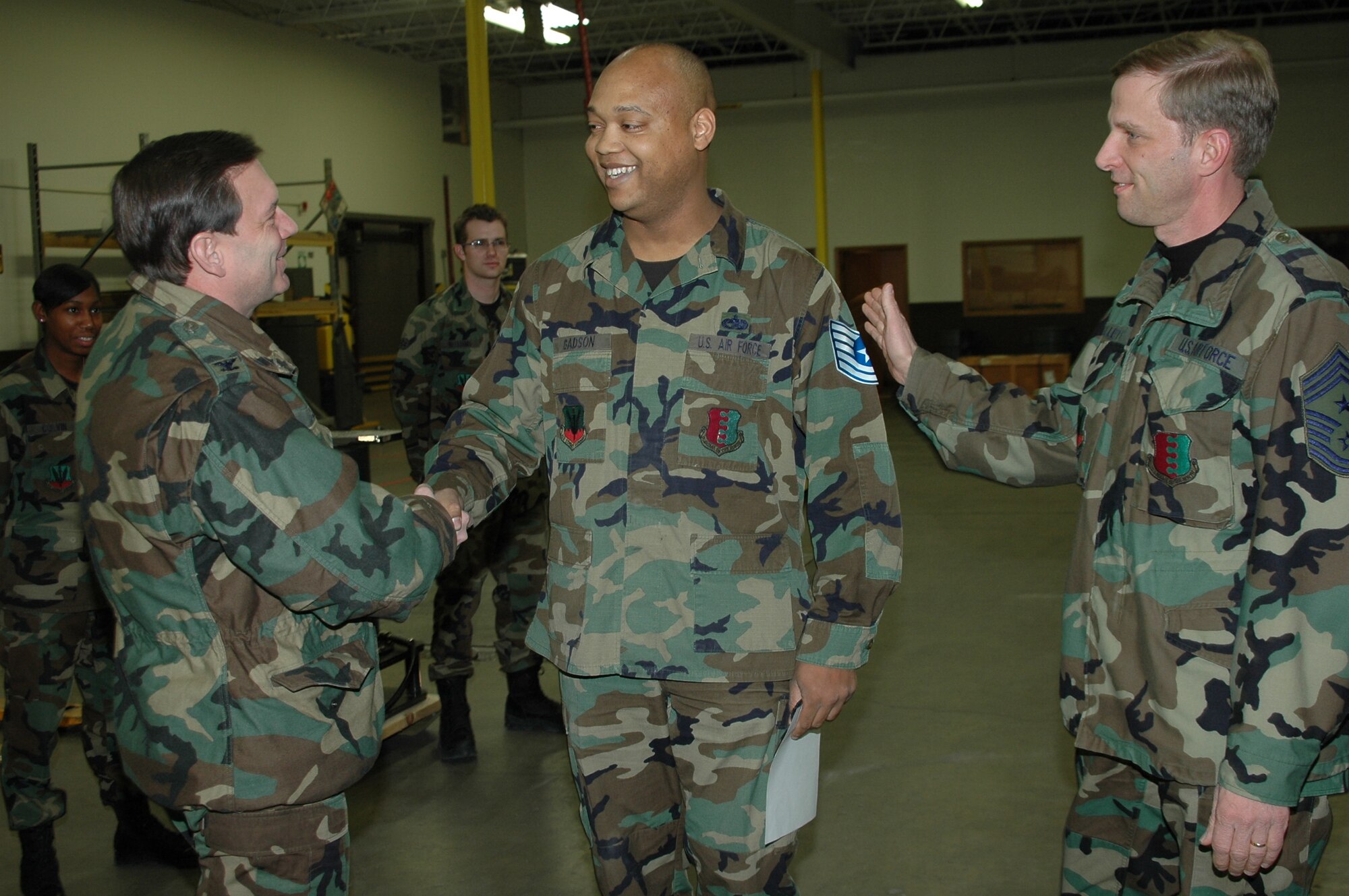 Col. Jeffry Smith, 28th Bomb Wing commander, and Command Chief Master Sgt. John Gillette, 28th BW command chief, congratulate Tech. Sgt. Joseph Gadson, 28th Logistics Readiness Squadron traffic management supervisor, on his promotion Feb. 2. Sergeant Gadson was promoted under the Air Force’s Stripes for Exceptional Performers program. The logistician was recognized for his extraordinary leadership skills, his implementation of quality control checklists involving hazardous material shipments and his involvement in shipping 2,800 pounds of B-1 parts to support the global war on terrorism. (U.S. Air Force photo/Capt. Carrie L. Kessler)

