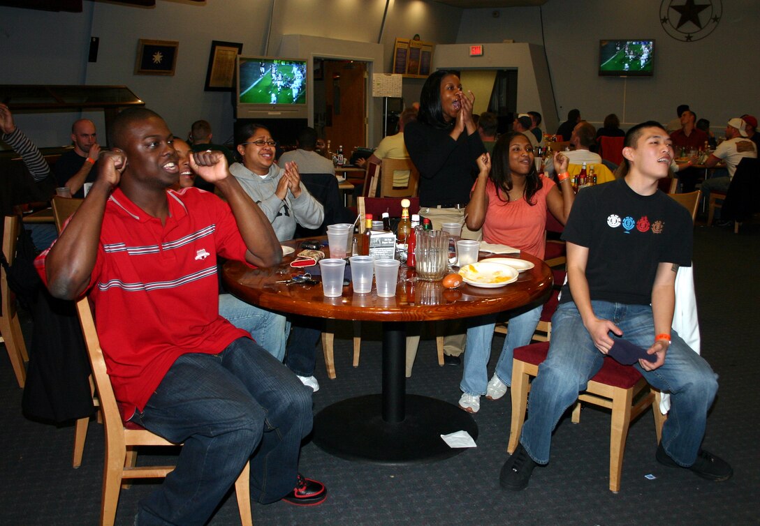 Football fans show their excitement as they watch the Super Bowl at the Sheppard Club Feb. 4. (U.S. Air Force photo/Airman 1st Class Jacob Corbin) 