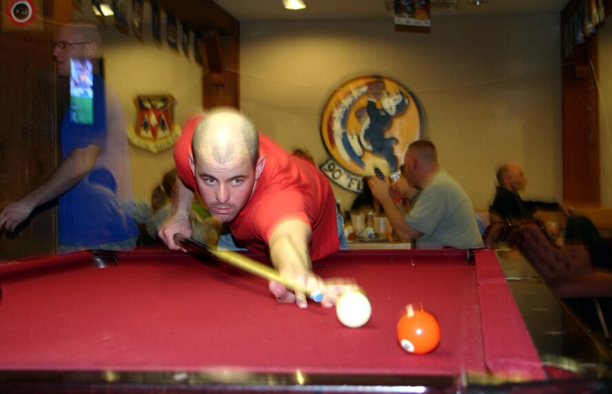 Staff Sgt. Andrew Baker, a student at the munitions inspection course with the 363rd Training Squadron, makes a shot playing pool at the Sheppard Club Feb. 4. Sergeant Baker was watching the Super Bowl at the Sheppard Club with friends. (U.S. Air Force photo/Airman 1st Class Jacob Corbin)