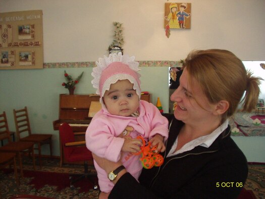 Michelle Nett, wife of Capt. (Dr.) Randall Nett, holds Tatyana--the daughter the Netts adopted from Kazakhstan.