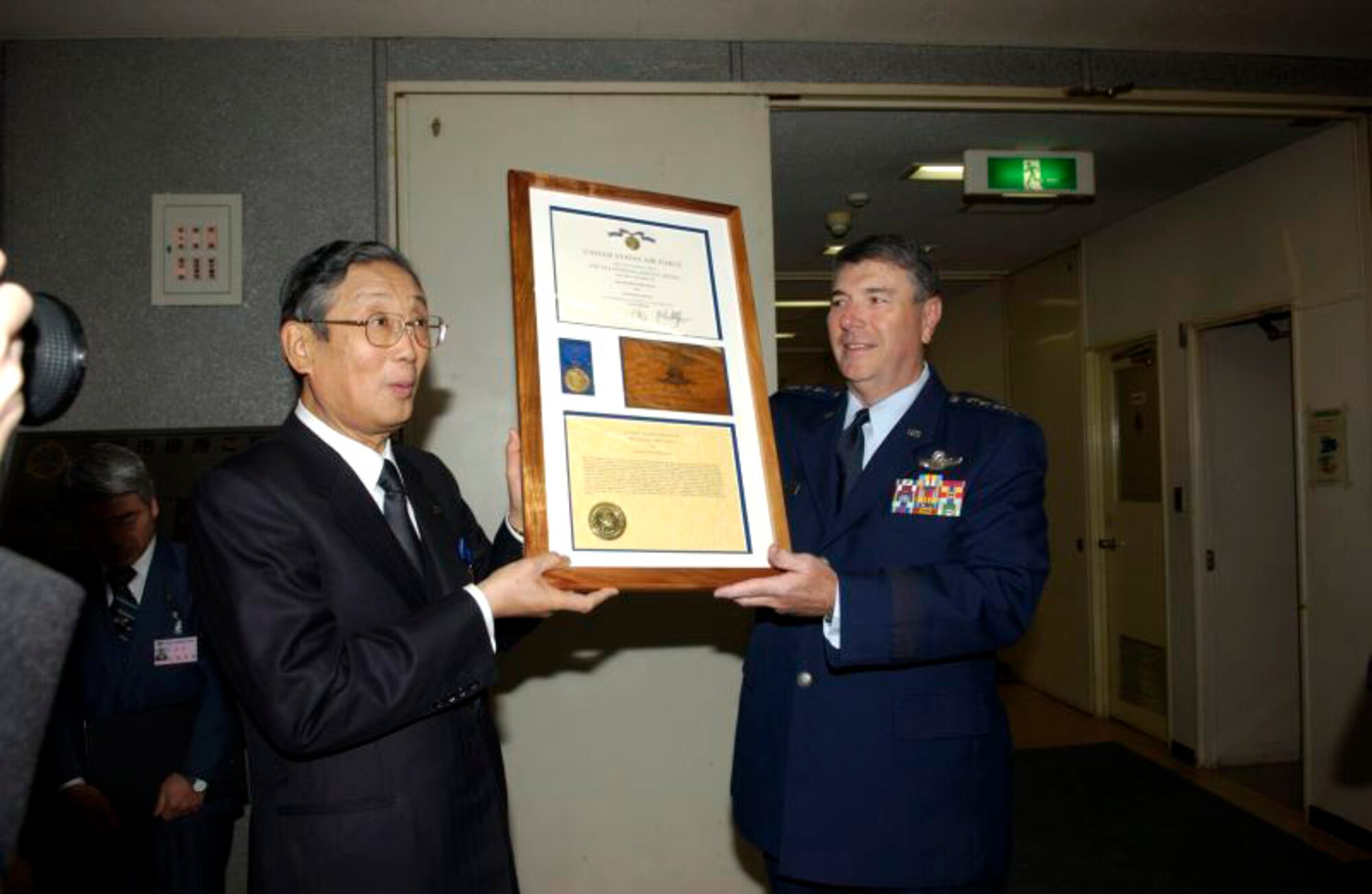 Gen. Paul V. Hester presents the Air Force Exemplary Civilian Service award to Misawa City Mayor Shigeyoshi Suzuki Jan. 31 in Misawa City. General Hester is the Pacific Air Forces commander. (U.S. Air Force photo/Senior Airman Robert Barnett)