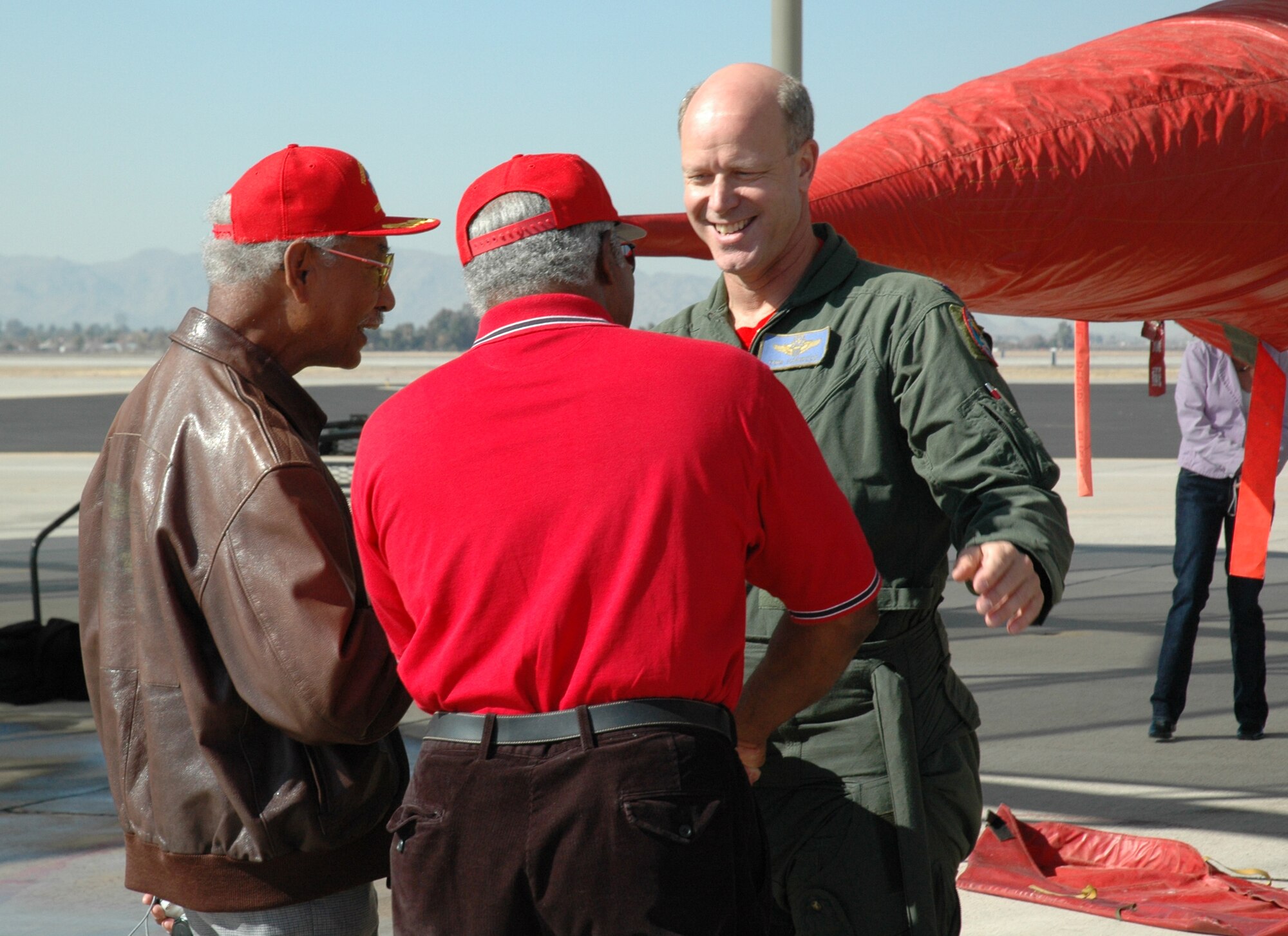 Tuskegee Airmen Lt Col. (ret) Robert Ashby, left, and Col. (ret) Richard Toliver, congratulate Col. Thomas Harwood, 944th Fighter Wing vice commander, on his fini flight in a 944th Fighter Wing jet. The last three of the wing's 17 jets depart Feb. 12, 2007, as part of Base Realignment and Closure actions. (U.S. Air Force photo/Staff Sgt. Susan Stout)