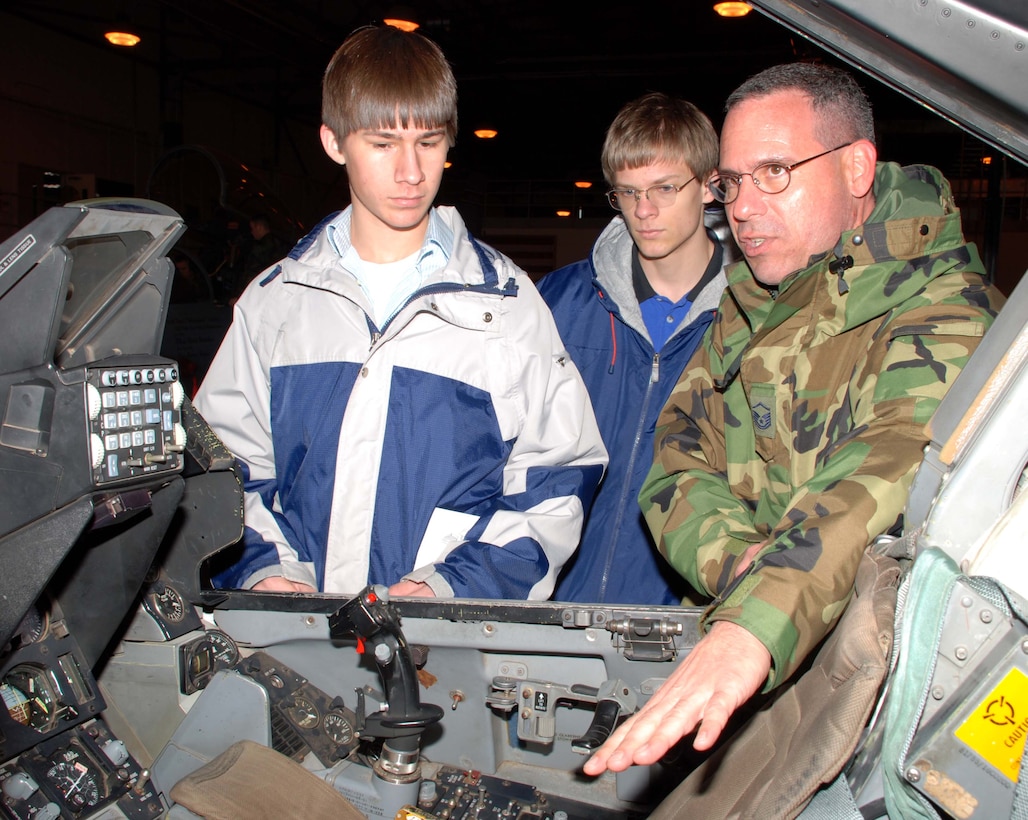 Dustin Trevino from Petrolia High School and Brandon Tiedeman from City View High School get an upclose view of an F-16 cockpit. Master Sgt. Peter Bushnell, Flight Superintendent Fighter Avionics,  explains how training is conducted on the F-16 Ground Instructional Training Aircraft. Mr. Trevino and Mr. Tiedeman participated in the annual Ground Hog Job Shadow Day. (U.S. Air Force photo/Tech. Sgt. Jennifer Isom)