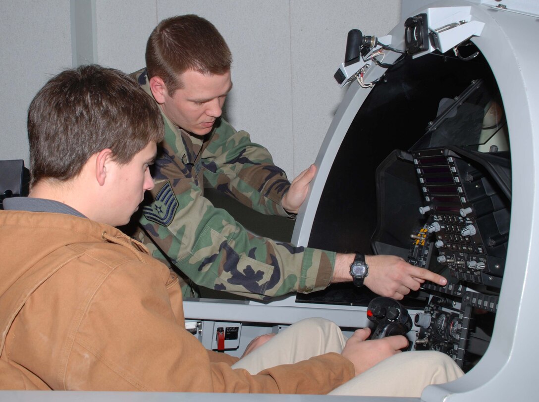 Henry Daugherty from Rider High School receives one-on-one instruction on the F-15E Maintenance Training Simulator from Tech. Sgt. Terry Bullock, an F-15 Avionics instructor. Mr. Daughtery participated in the annual Ground Hog Job Shadow Day. (U.S. Air Force photo/Tech. Sgt. Jennifer Isom)