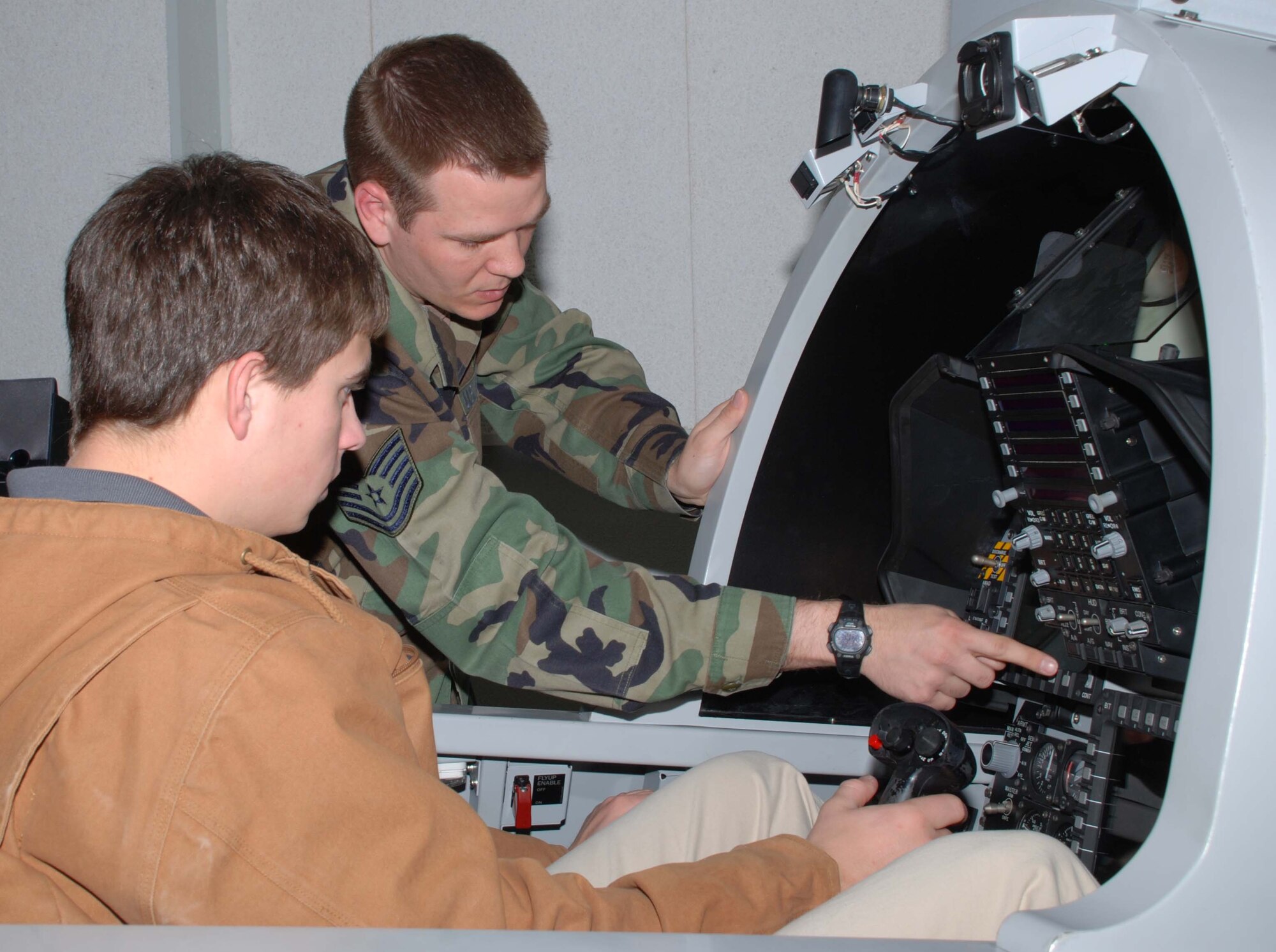 Henry Daugherty from Rider High School receives one-on-one instruction on the F-15E Maintenance Training Simulator from Tech. Sgt. Terry Bullock, an F-15 Avionics instructor. Mr. Daughtery participated in the annual Ground Hog Job Shadow Day. (U.S. Air Force photo/Tech. Sgt. Jennifer Isom)