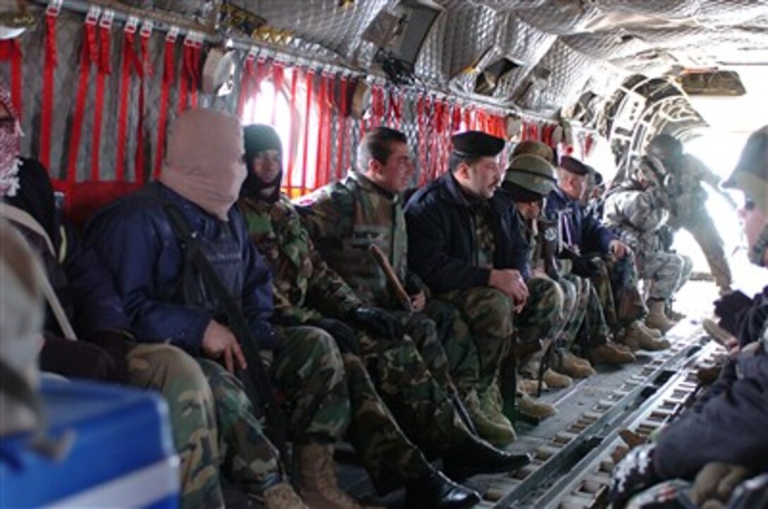 Iraqi soldiers with Coalition troops sit in a CH-47 Chinook helicopter as it prepares to take them back to base, Jan. 31, 2007. The helicopter provided transportation to and from the troops' objective near Kirkuk, Iraq.