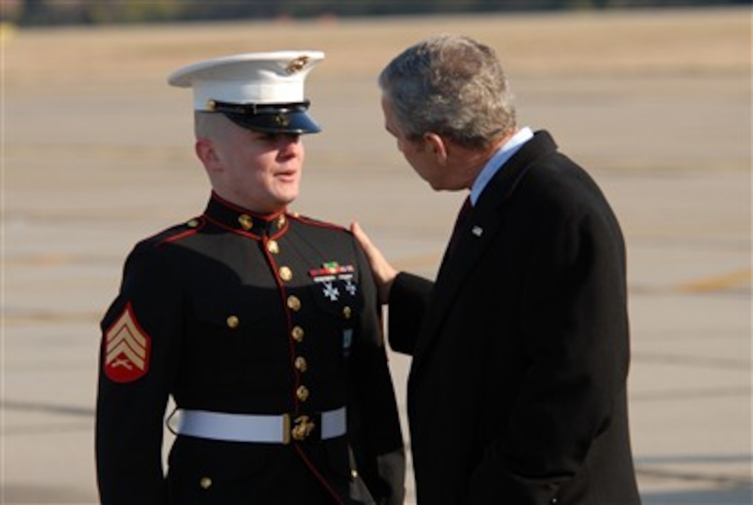 President George W. Bush is greeted by U.S. Marine Corps Sgt. Justin Alvarez during his arrival at the Newport News/Williamsburg International airport in Newport News, Va., on Feb. 3, 2007.  Alvarez was selected along with nine other military personnel to greet the president.  