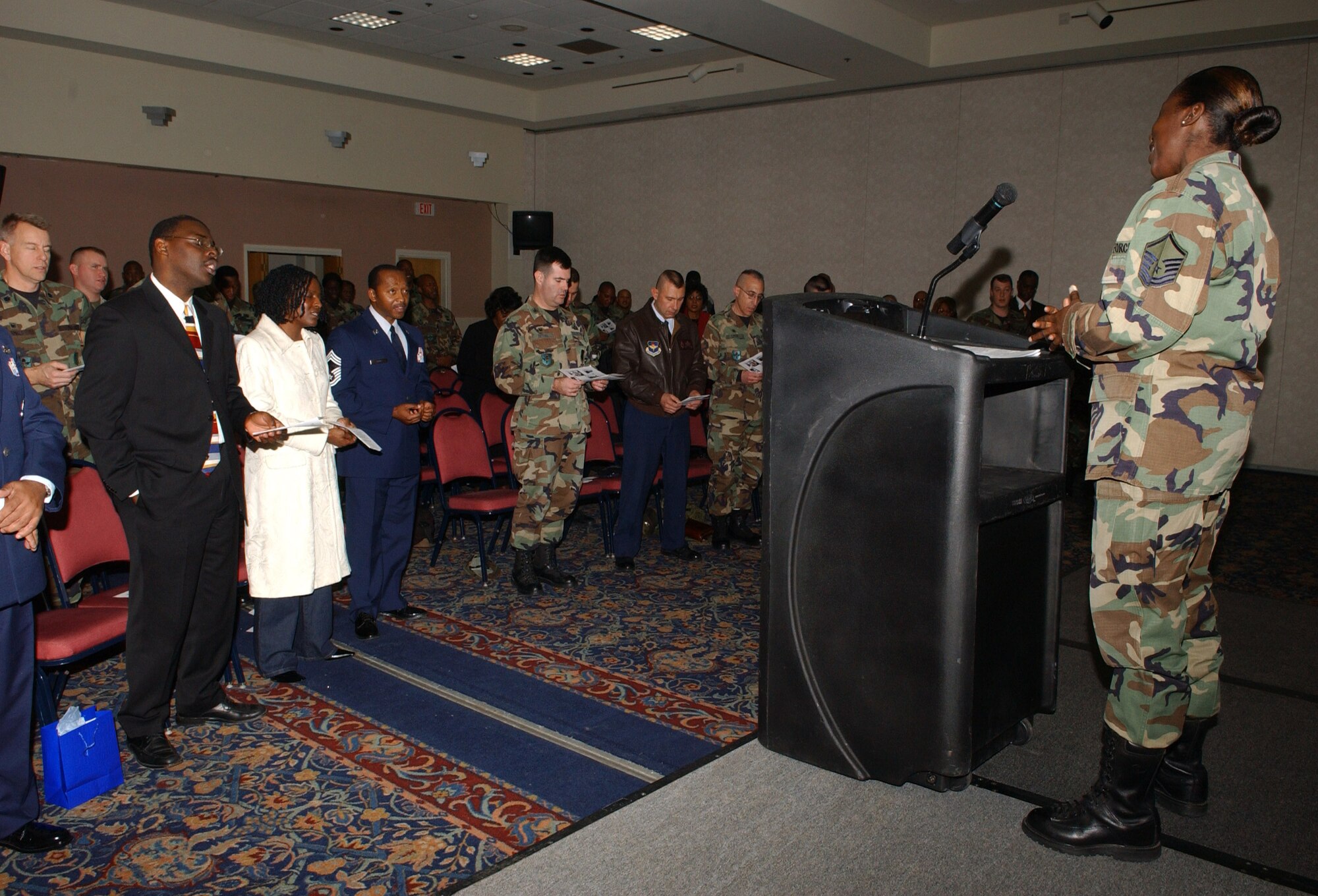 Air Force Master Sgt. Roberta Pemberton (far right) leads guests in singing "Lift Every Voice and Sing."   (U.S. Air Force photo by Airman 1st Class Kamaile Chan)
