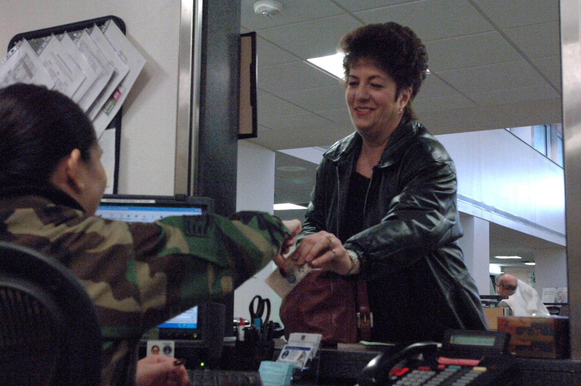 Staff Sgt. Dana Reyes checks Karin Hartman in Feb. 6 for her morning appointment at the Air Force Academy hospital. The Academy hospital was awarded the Defense Department's Medical Treatment Facility Patient Satisfaction Award for fiscal year 2006.  Sergeant Reyes is a family practice technician with the 10th Medical Group.  (U.S. Air Force photo)
