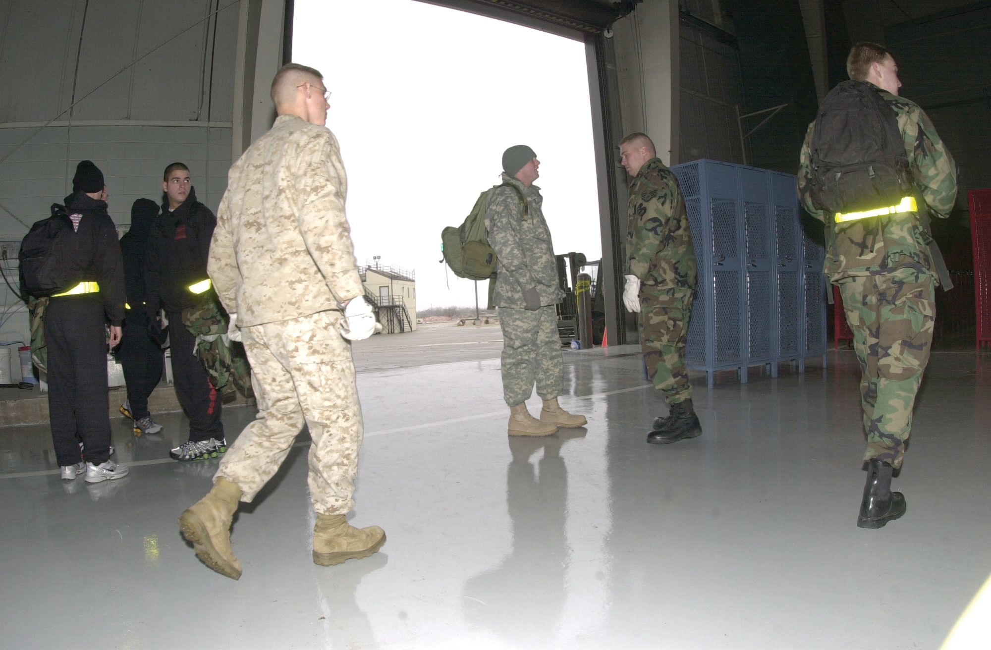 Members of the Fire Academy walk on the newly renovated, 43,000 square-foot floor of the high bay.  (U.S. Air Force photo by Airman 1st Class Luis Loza Gutierrez)