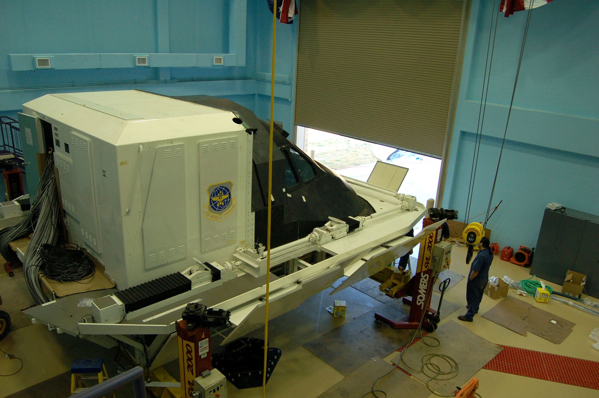 Workers install a C-5 Galaxy flight simulator at the Air Force Reserve Command's 433rd Airlift Wing at Lackland Air Force Base, Texas. The 356th Airlift Squadron and 733rd Training Squadron joined the wing Feb 6, making it the Air Force's C-5 formal training unit. The wing's C-5 aircraft fly out of adjacent Kelly Field.  (U.S. Air Force photo/Master Sgt. Collen McGee) 